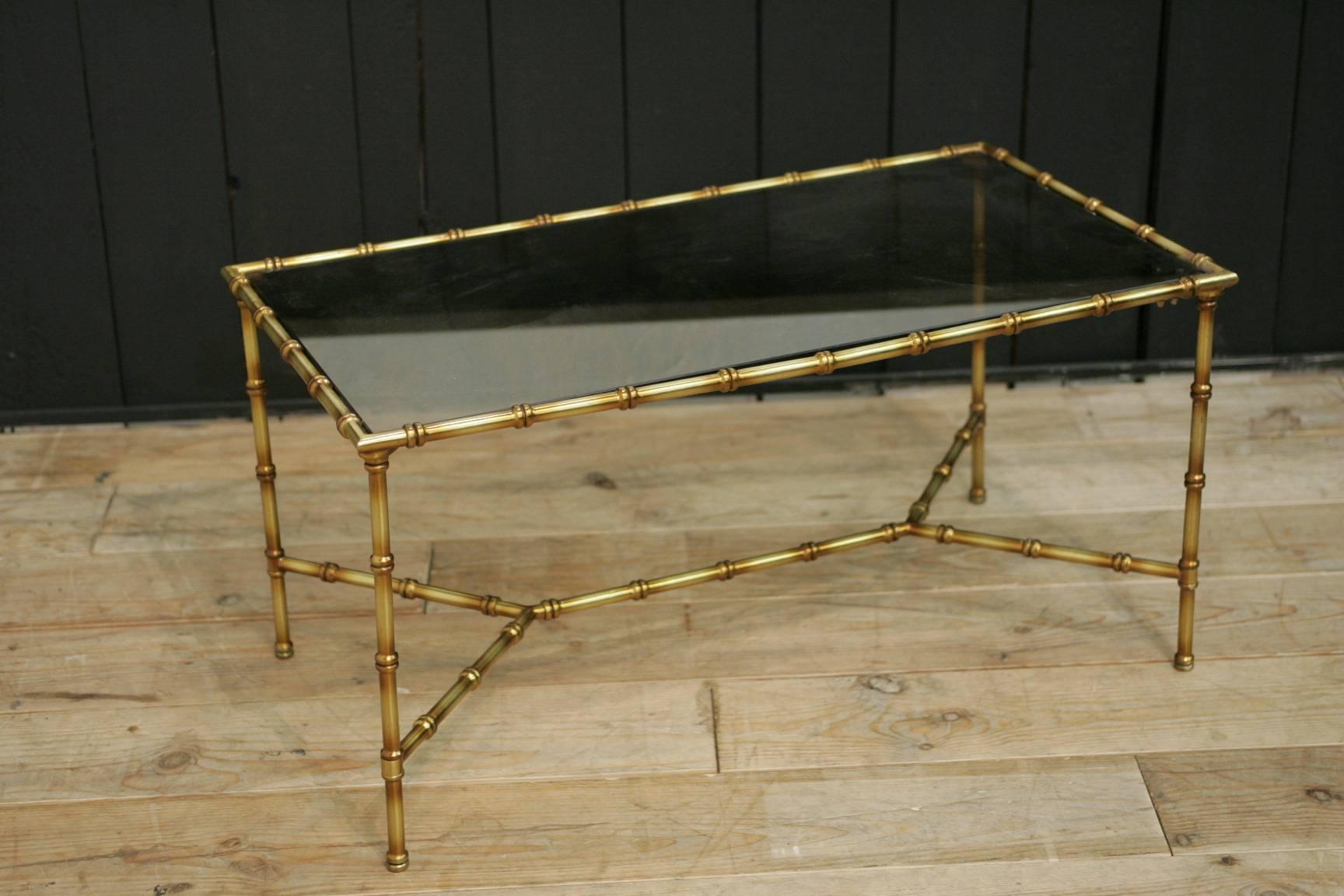 A nice coffee table in the manner of Maison Bagués and made of gilded metal.
Heavy metal.