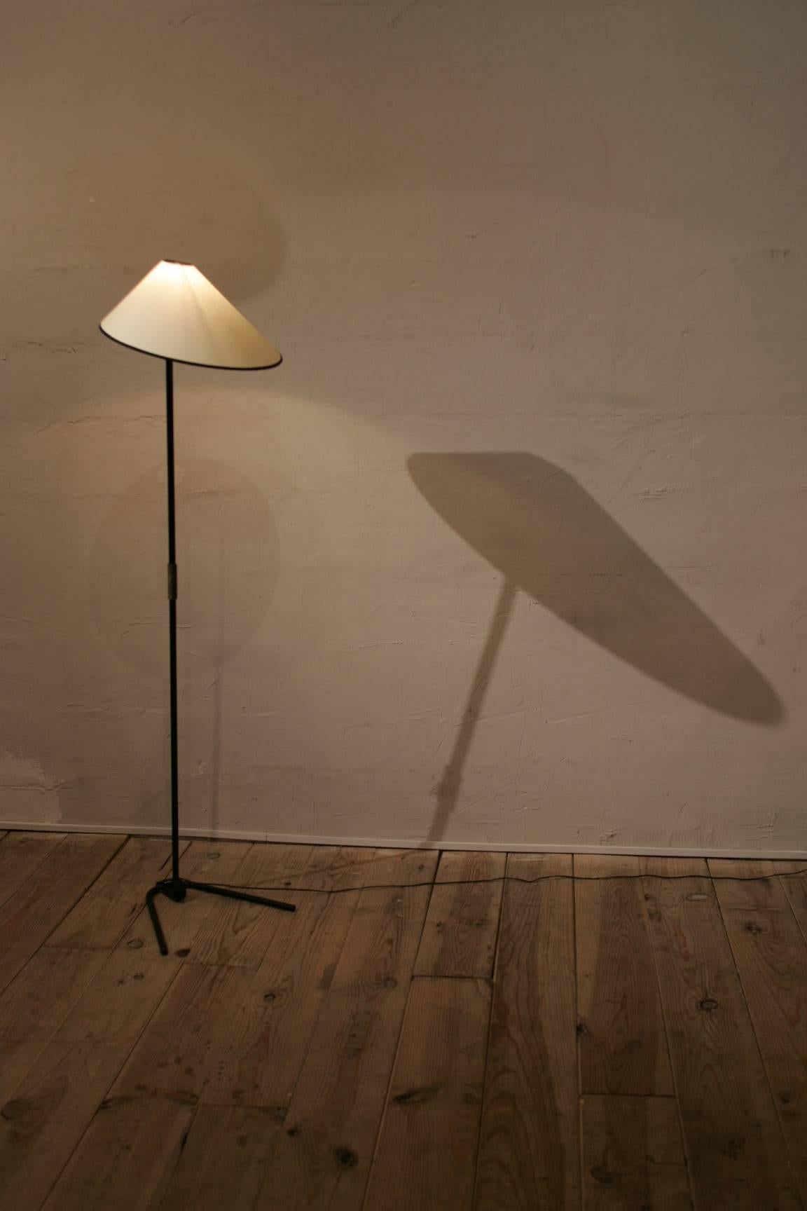A very nice floor lamp in the manner of Jean Royére circa 1960 made of black painted steel,brass and  newmodulable 