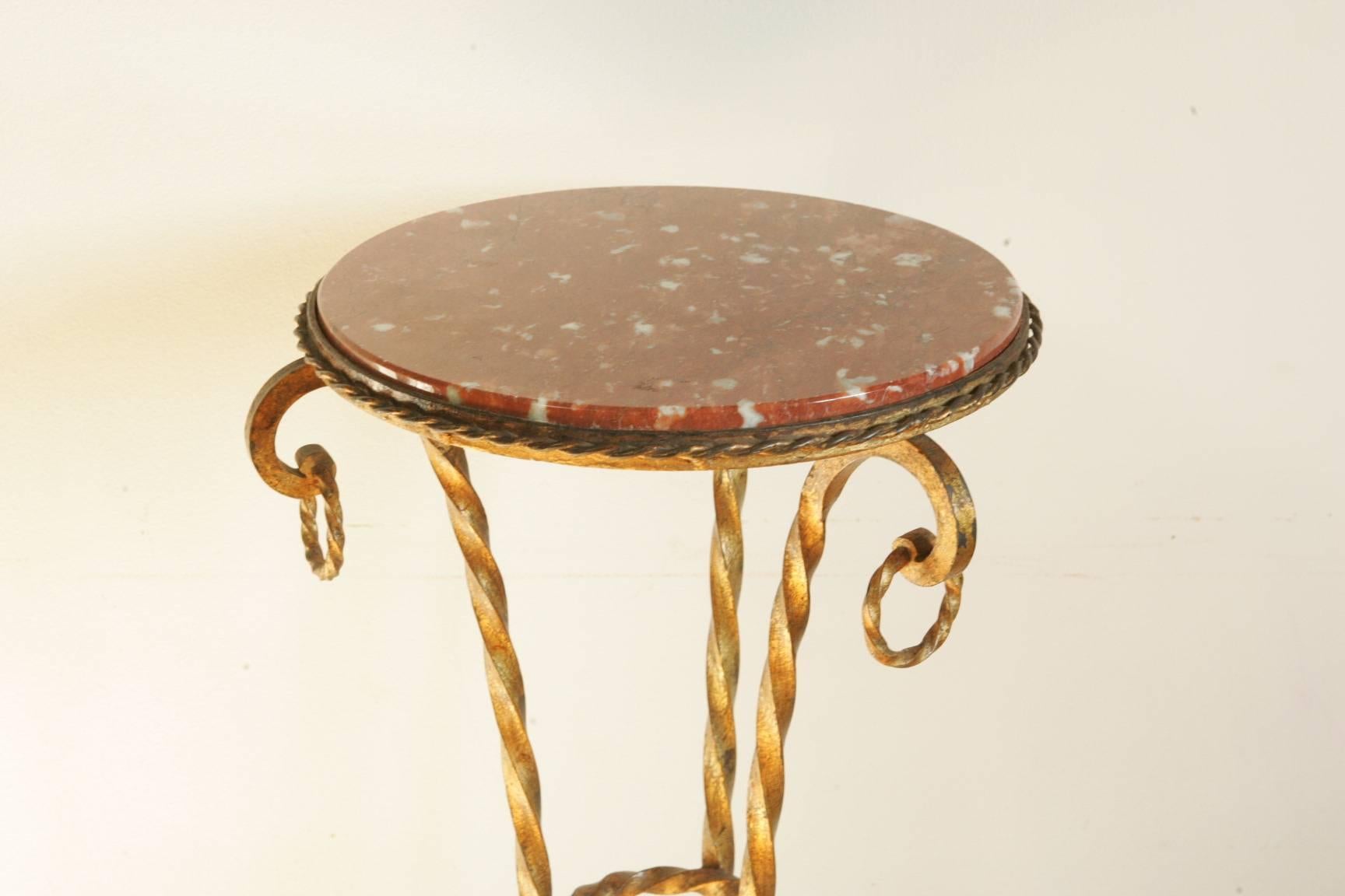A nice golden fire iron gueridon or piedestal in the manner of Gilbert Poillerat, circa 1960 with a nice marble-top.