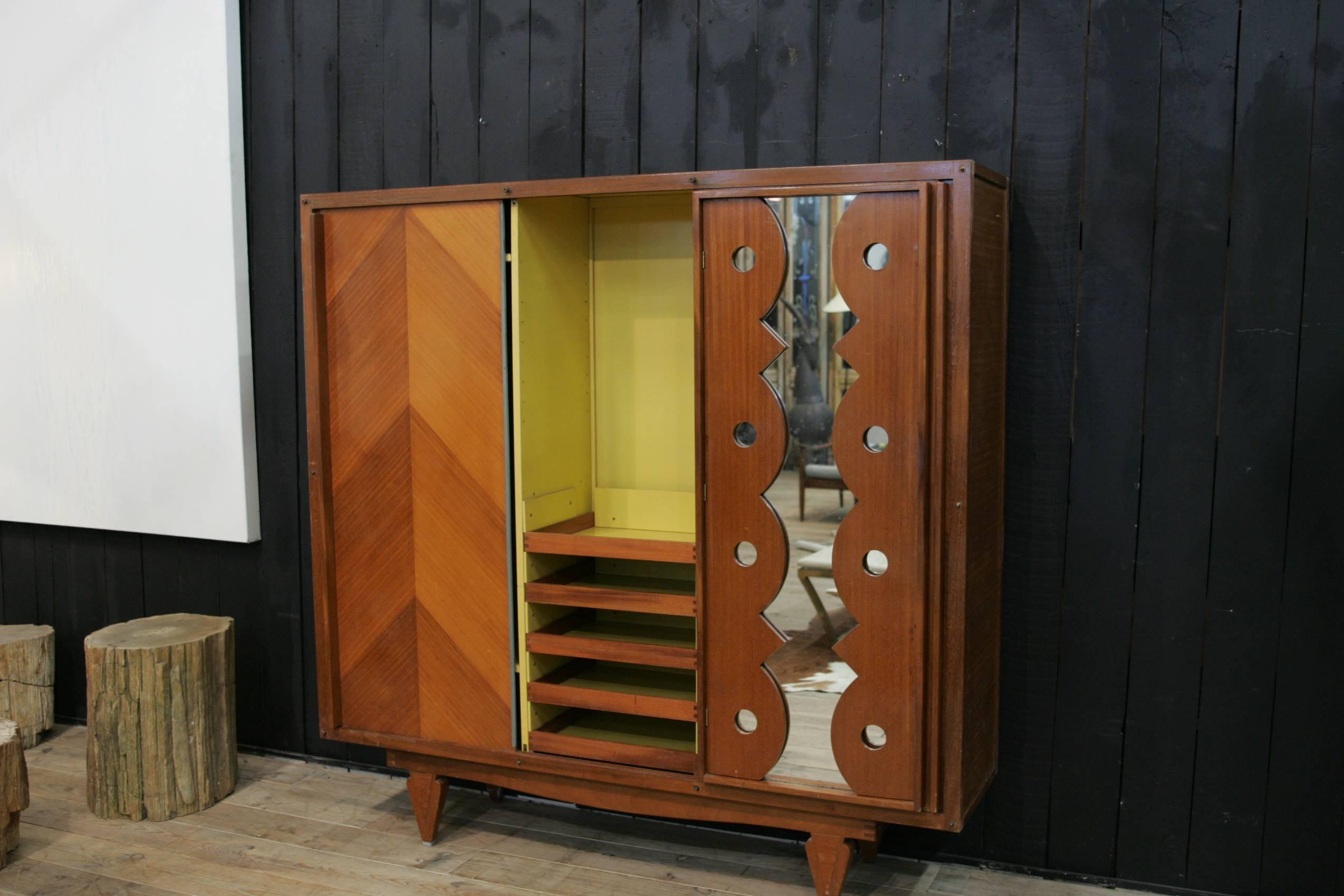 A beautiful wardrobe created by André Sornay lacquered in mustard color from origin.