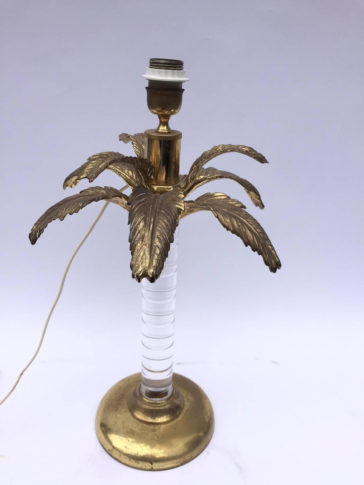 This beautiful table lamp in the shape of the palm tree on polished brass base and Lucite tree steam with a beautiful palm leaves in brass, Italy, circa 1960s.
Brass base: 20 cm. or 8 in. in diameter.