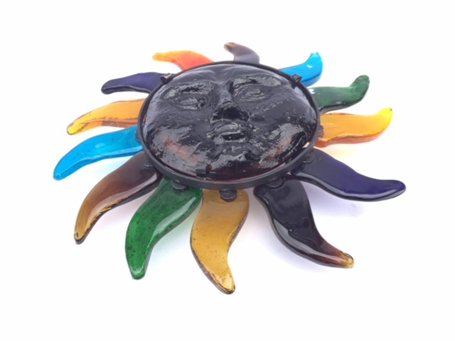 A pair unusual sunburst wall lights in multicolored glass and metal structure supporting the face of the sun, Mexican 1960s.