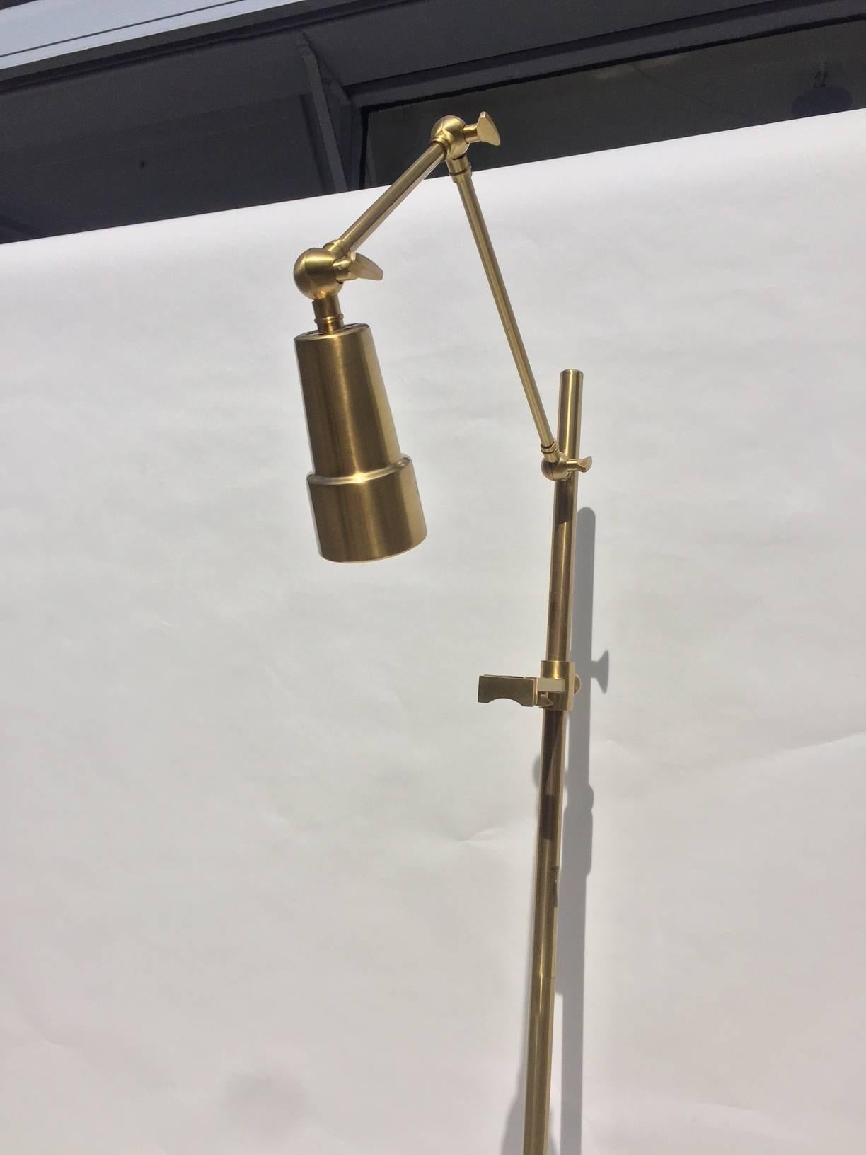 A 1970s Italian easel lamp in polished brass. The lamp has multiple adjustments to direct the light to any size artwork. Each support arm for the artwork are also adjustable in height and depth to secure your favorite artwork.