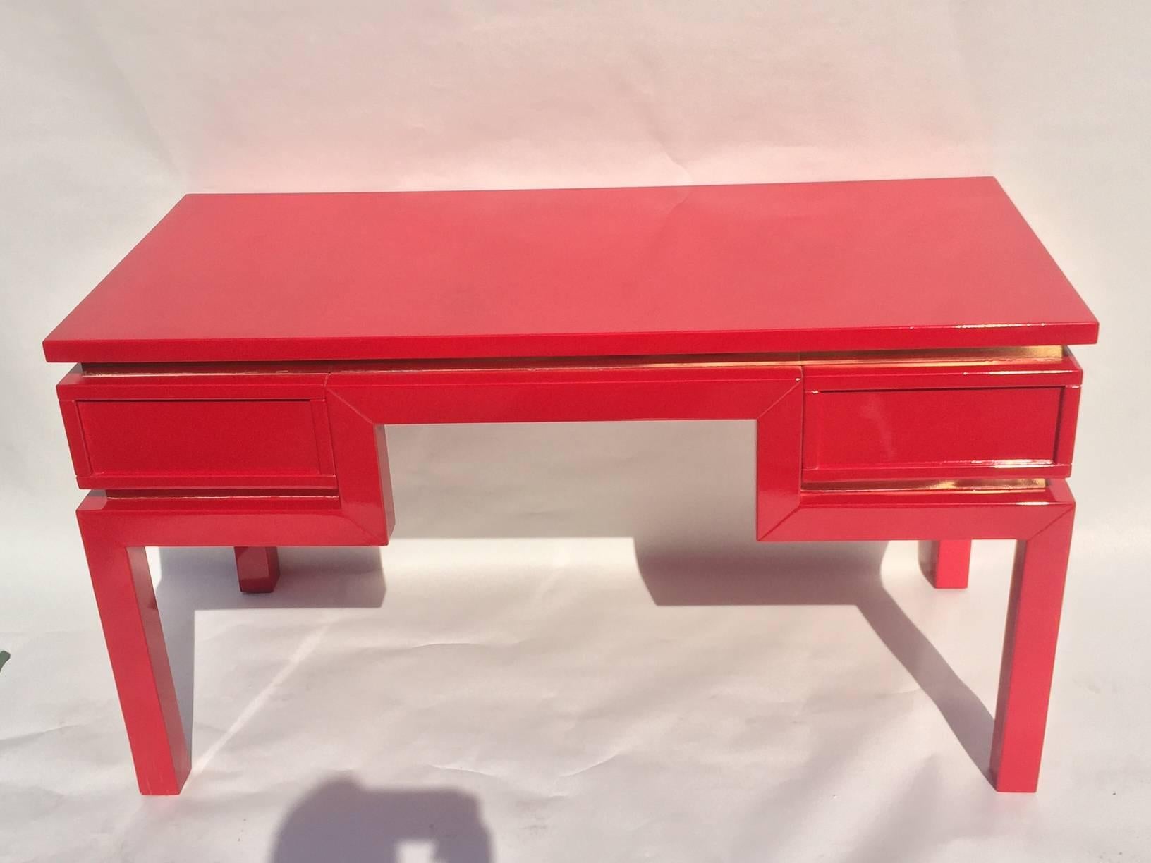 This desk very architectural design been re-lacquered in Ferrari red lacquer inline brass underneath the top surface and the bottom of the two drawers, with beautiful decorative handles in brass. Italian circa 1960s by Romeo Rega.