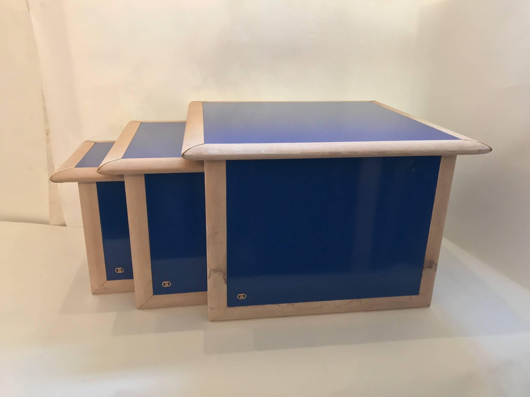 Italian, 1960s nest of tables by "Gucci", In Gucci blue lacquer and bone colour leather edges with decorative brass corners. With a "Gucci" logo on the sides.
Measures: 60 x 60 x 41cm. or 23.5 x 23.5 x 16in.
45 x 45 x 36cm. or