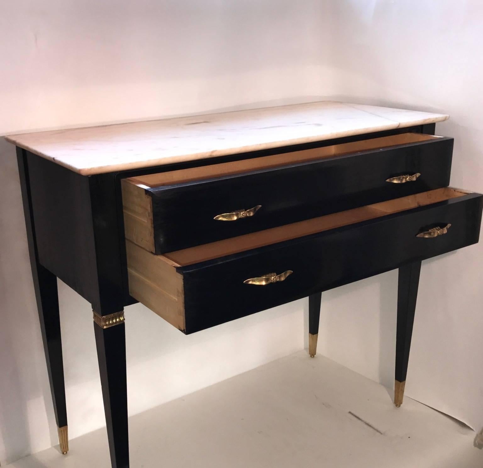 Vintage Italian 1940s elegant design chest of drawers with two drawers, polished black with a marble top, decorative brass handles and brass sabot on the feet. Designed by Paolo Buffa.