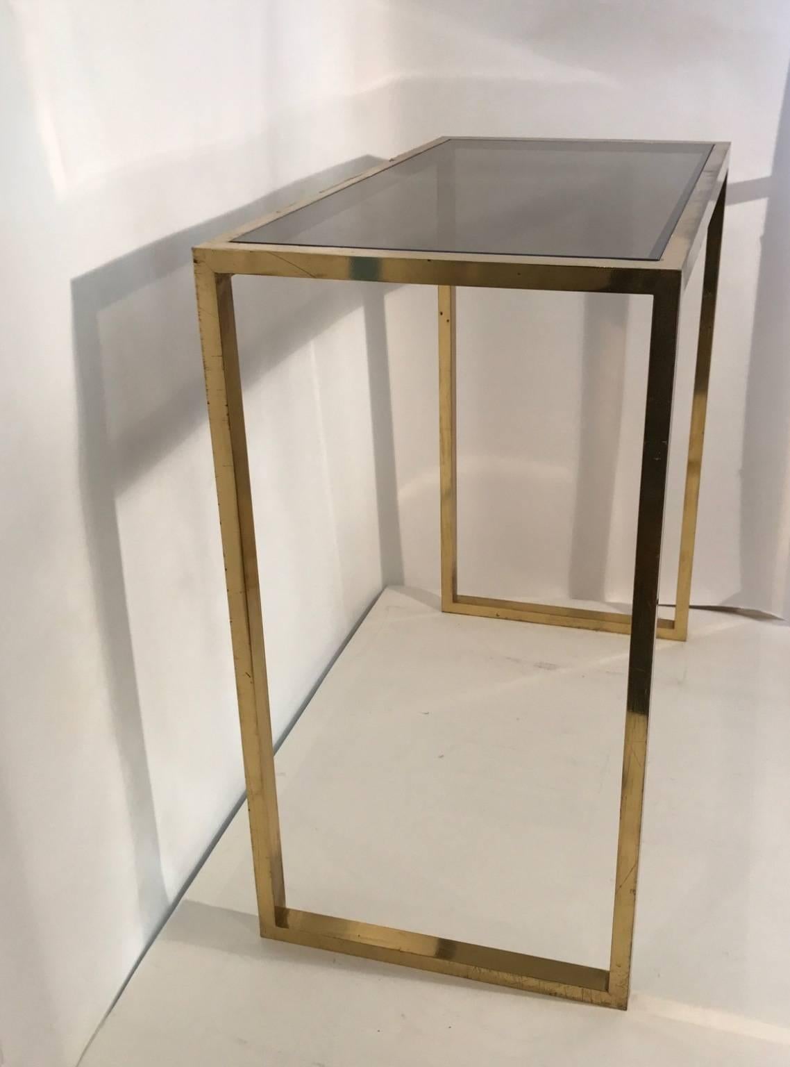 This simple design console in brass and smoked glass can be perfectly used as a dresser or the desk, Italian, 1960s.