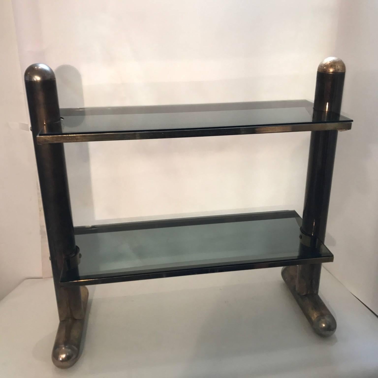 This unusual console or table with in two tiers of the smoked glass shelves and the combination of chrome endings and frame in antique polished metal.By Belgo chrome, Belgium, circa 1970s.