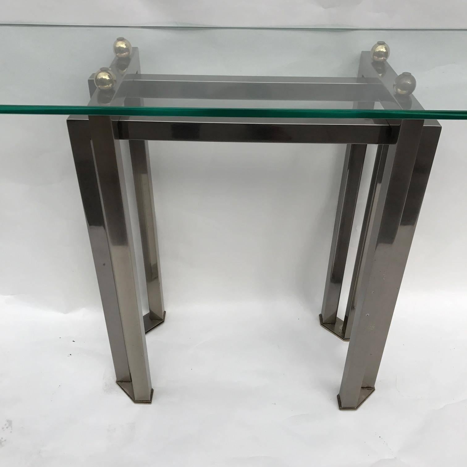 Belgium console table in polished chrome and brass balls supporting thick glass top. 1970s by Belgo Chrome.