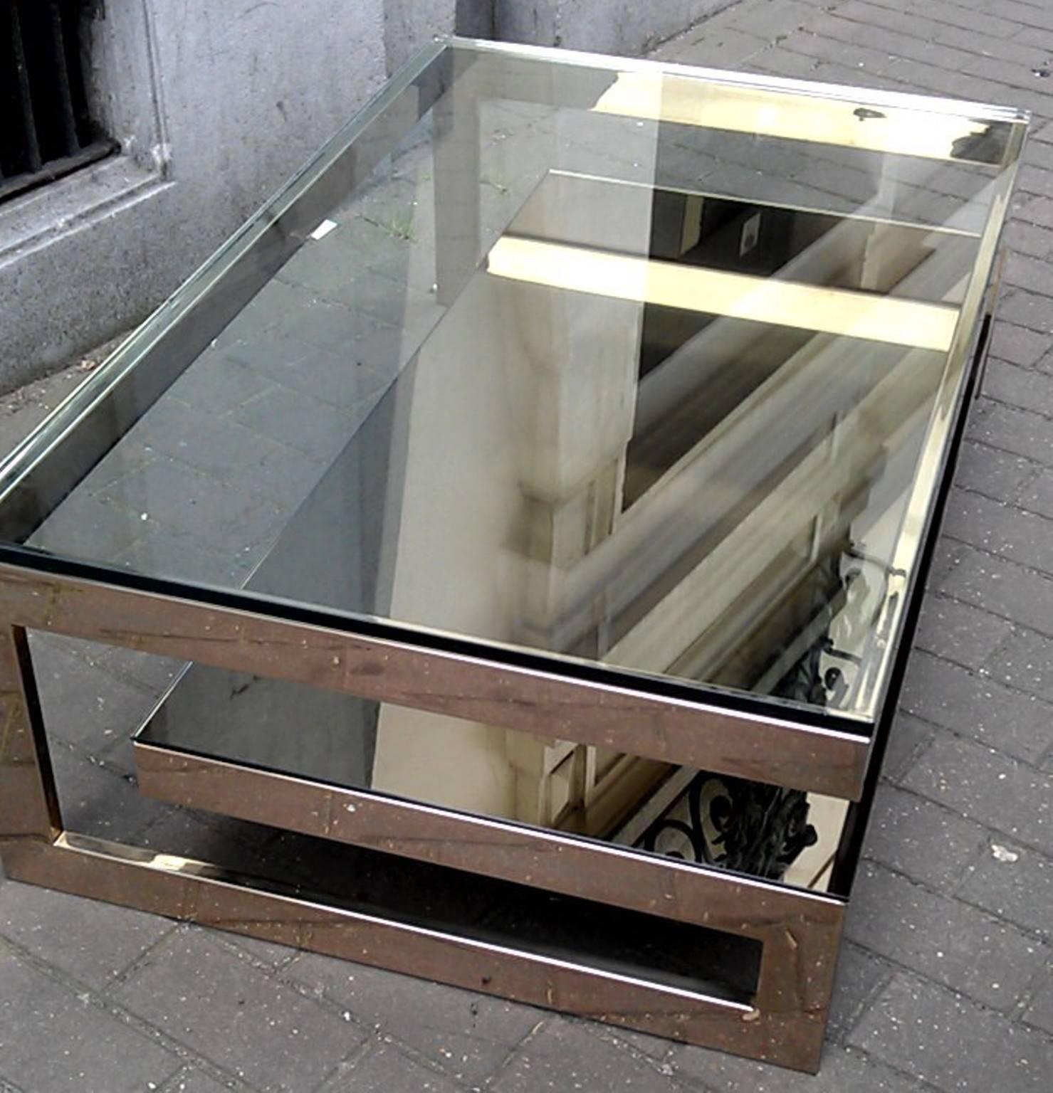 Beautiful coffee table by Belgo Chromo in 24-karat gold pate metal,
bottom shelve in smoke mirror and thick clear glass top, Belgium, 1970s.