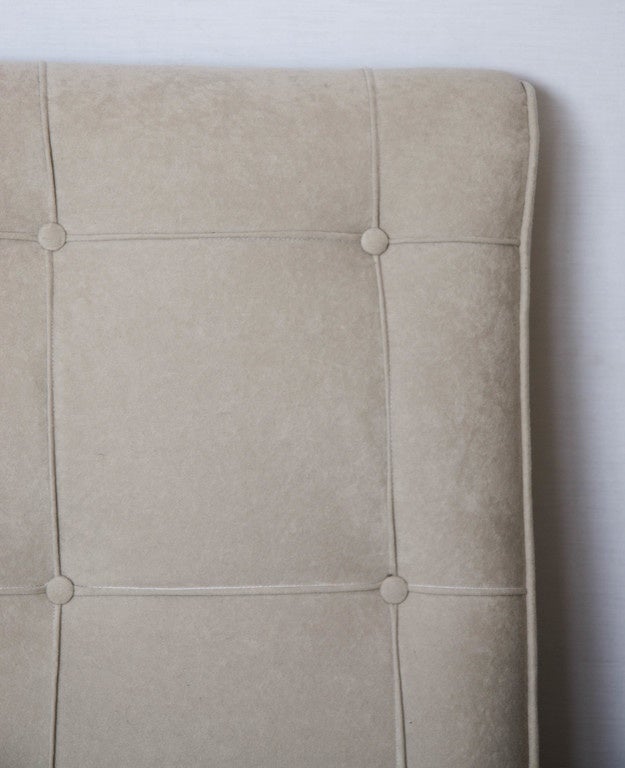 Large corner sofa upholstered in cream velvet on brass feet, in three separate sections.