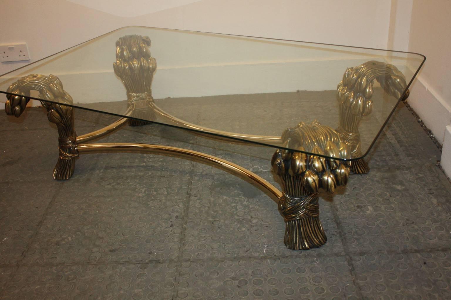 Nice and decorative coffee table in antique brass finish, imitating four bunches of wheat and nice glass top. 1970s Belgium