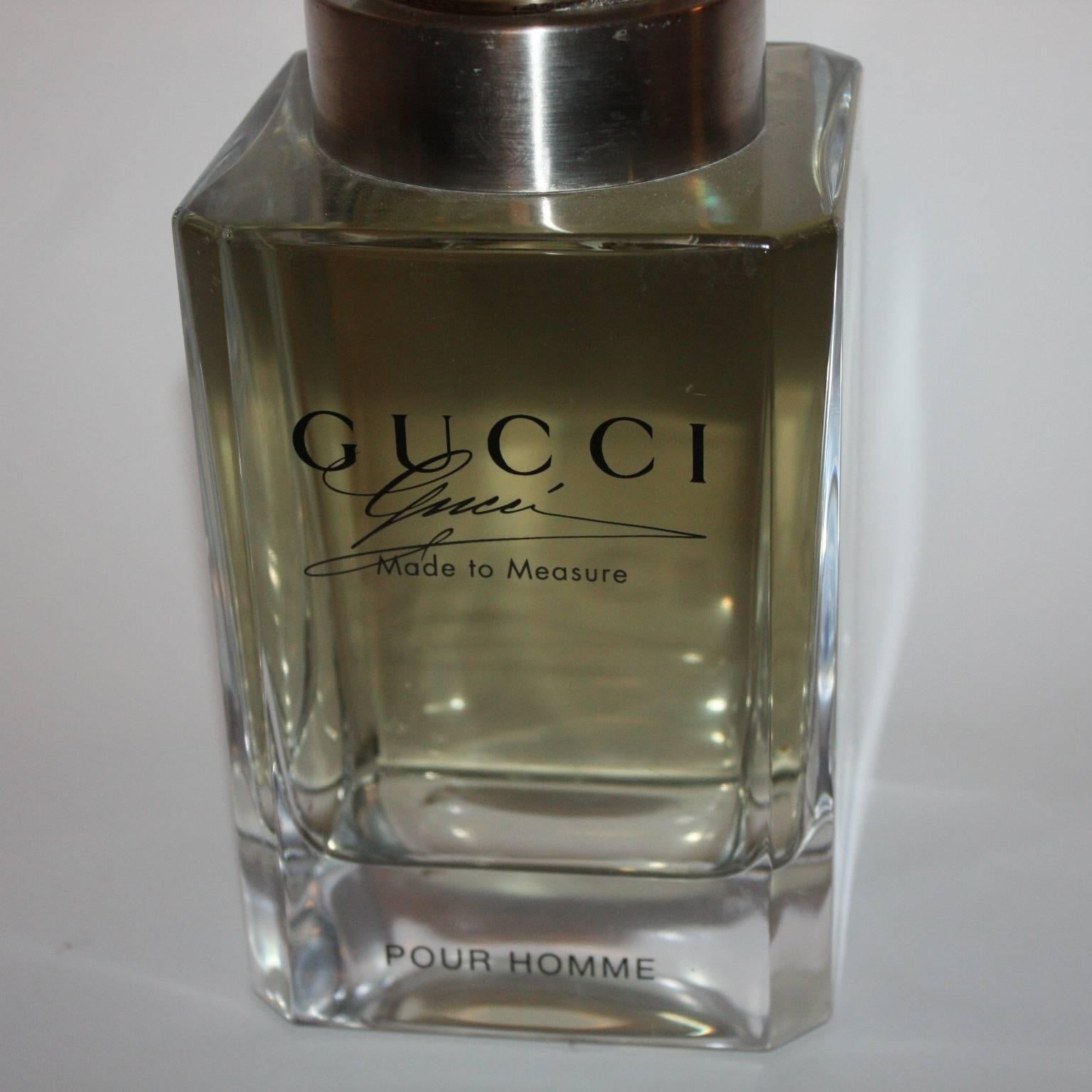 Decorative shop display Gucci perfume bottle with a brass top engraved Gucci, Italian, 1980s.