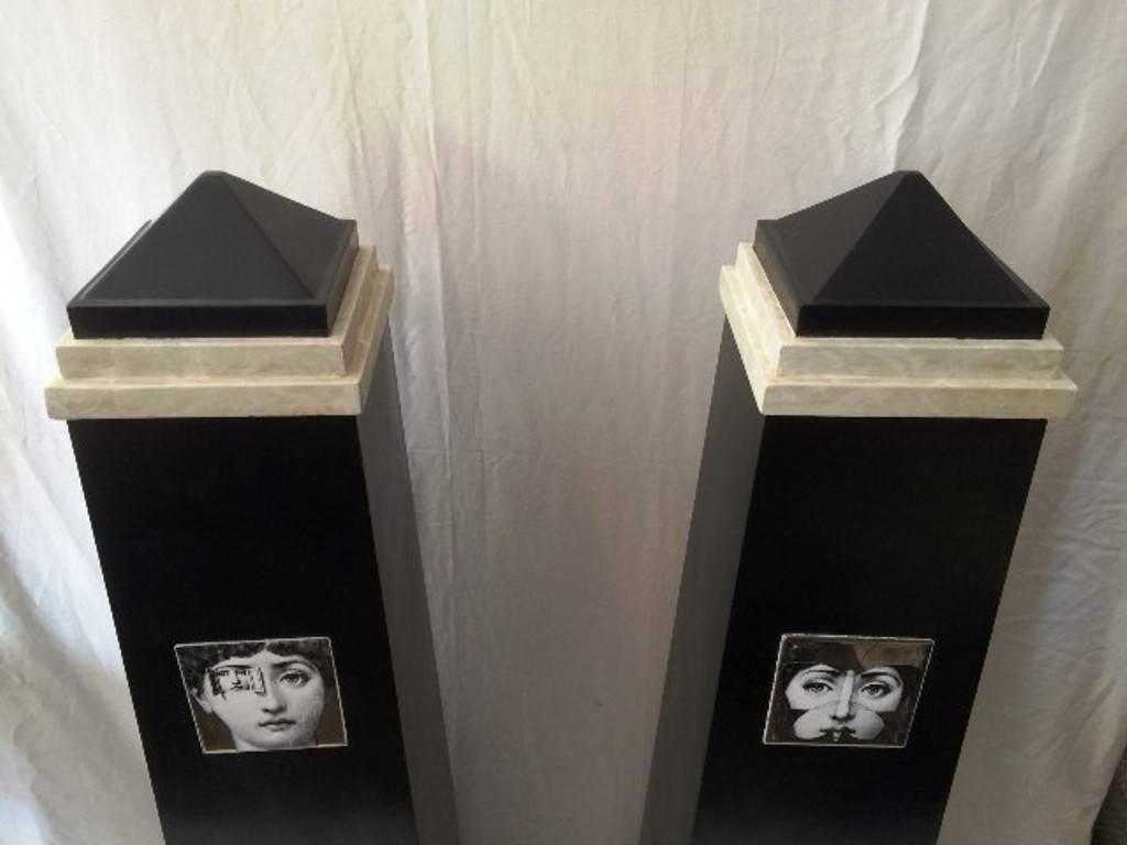 Pair of 1970's obelisks in the style of Piero Fornasetti, with Ceramic insets of tiles with fornasetti designs .