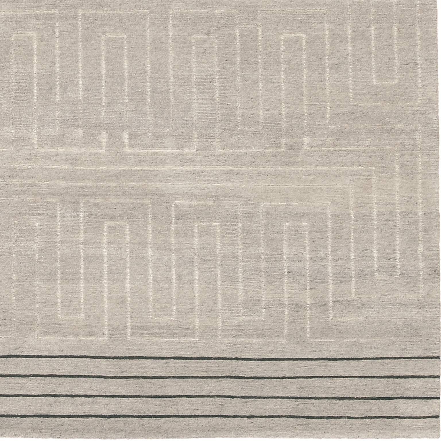 Contemporary 'Marion II' Grey Tibetan Wool and Silk Carpet
This Tibetan wool and silk rug was inspired by the modern aesthetic of the 20th century.
Enhancing its flossy textural feel, the field is un-dyed Tibetan and Ash wool, and its centre design