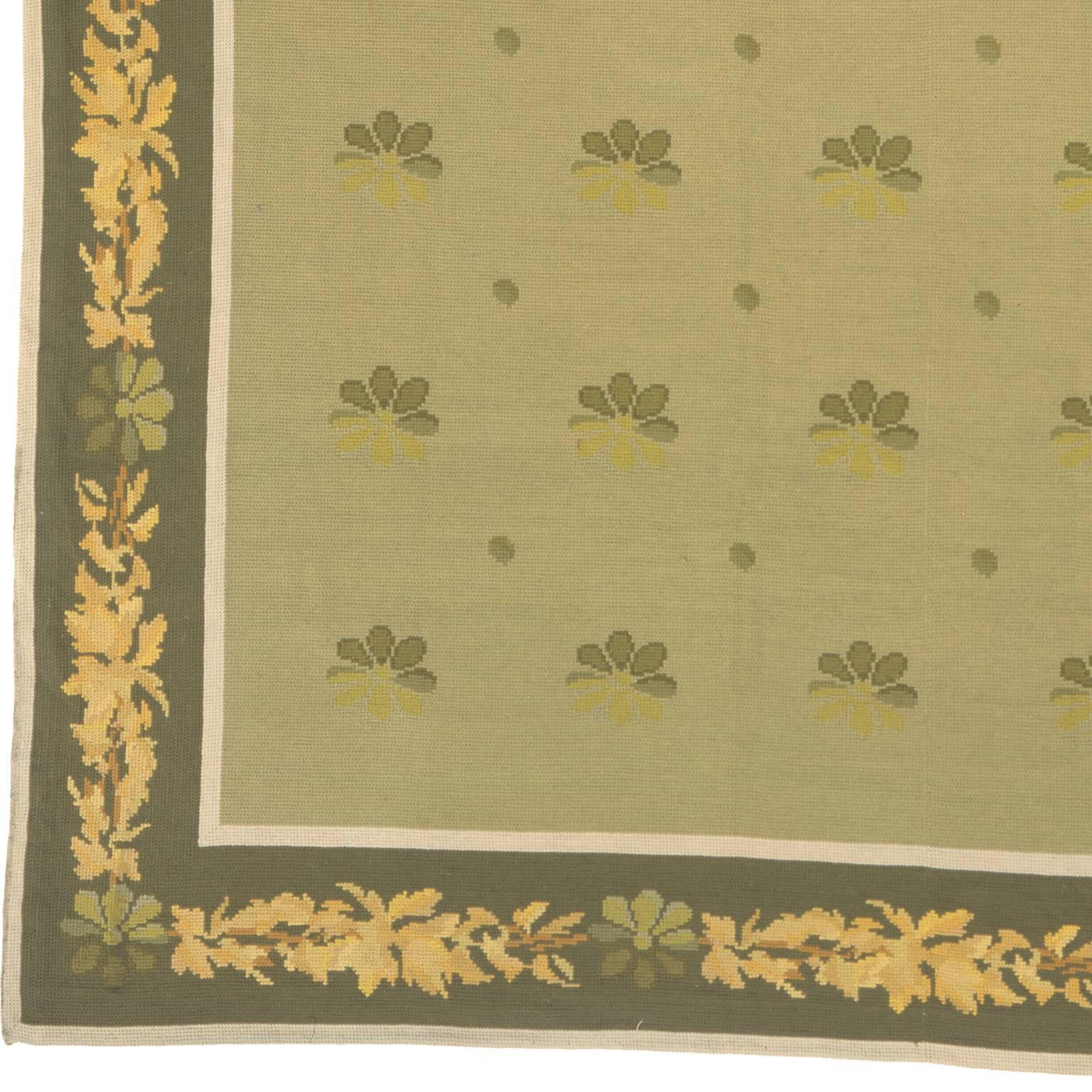 Arraiolos carpet, 1940
Portugal, circa 1940
The light green field with scattered stylized rosettes and dots in a moss green border of angular serrated leaves and rosette vine between plain stripes.