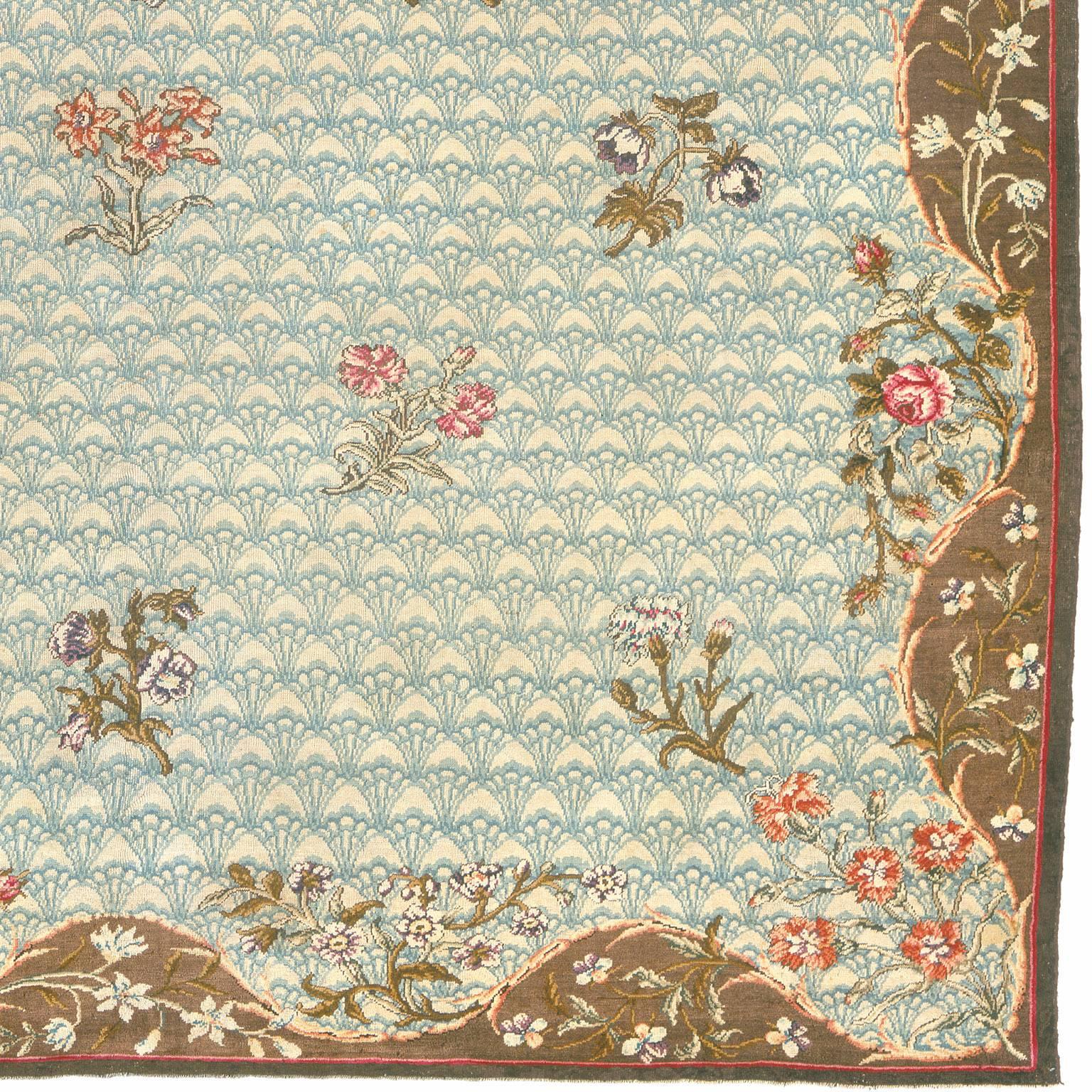 English Axminster rug, 1765
England, circa 1765
The ivory field with a tracery design of blue stylized leaves decorated with numerous floral sprays centered by a naturalistic flowering spray framed by mud brown spandrels enclosed by a narrow
