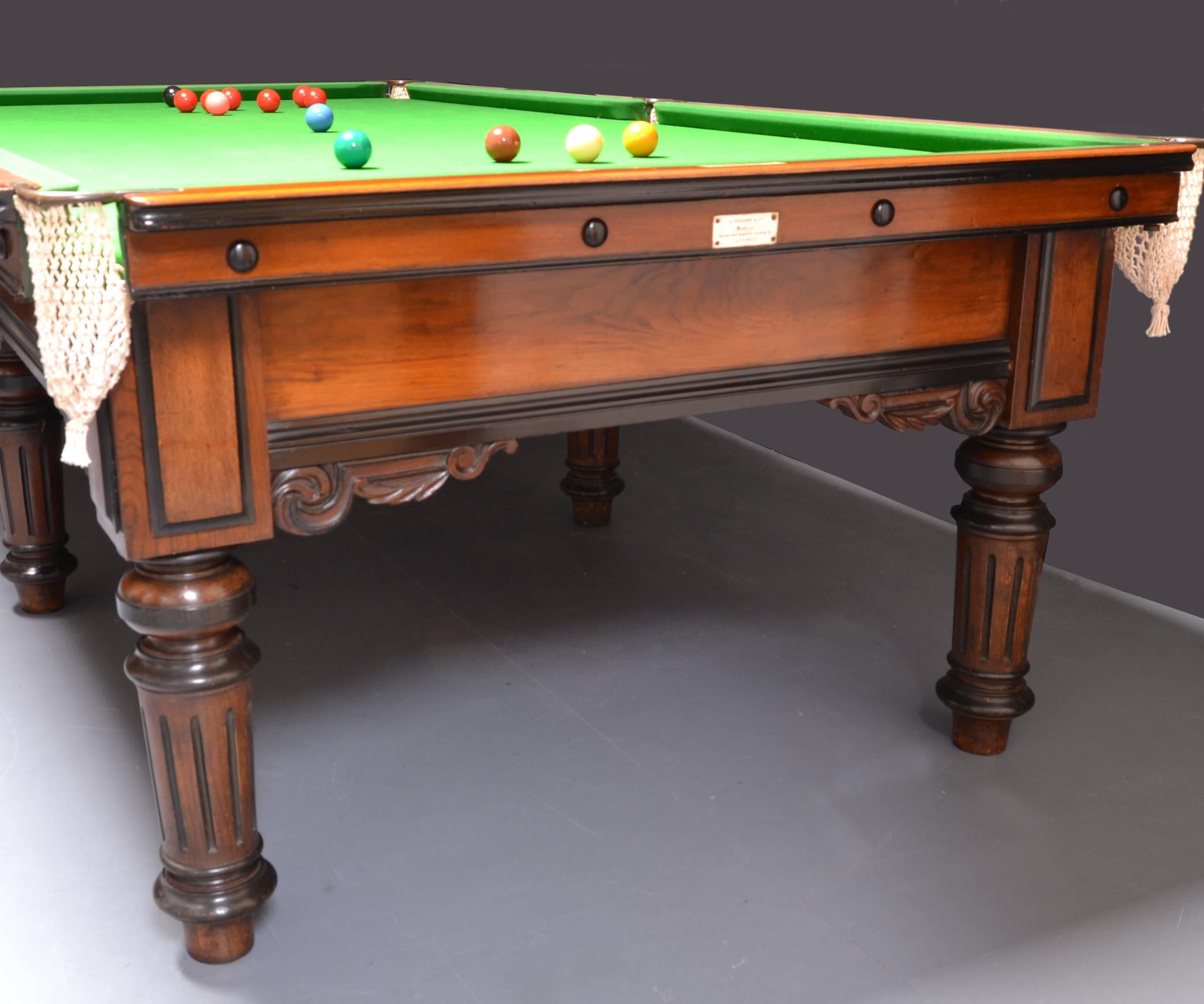 This oak framed three quarter size antique billiard snooker table stands on six elegant turned and fluted legs with carved corbel brackets to the side frame. 

The table is finished in an attractive golden oak with ebonised mouldings and applied