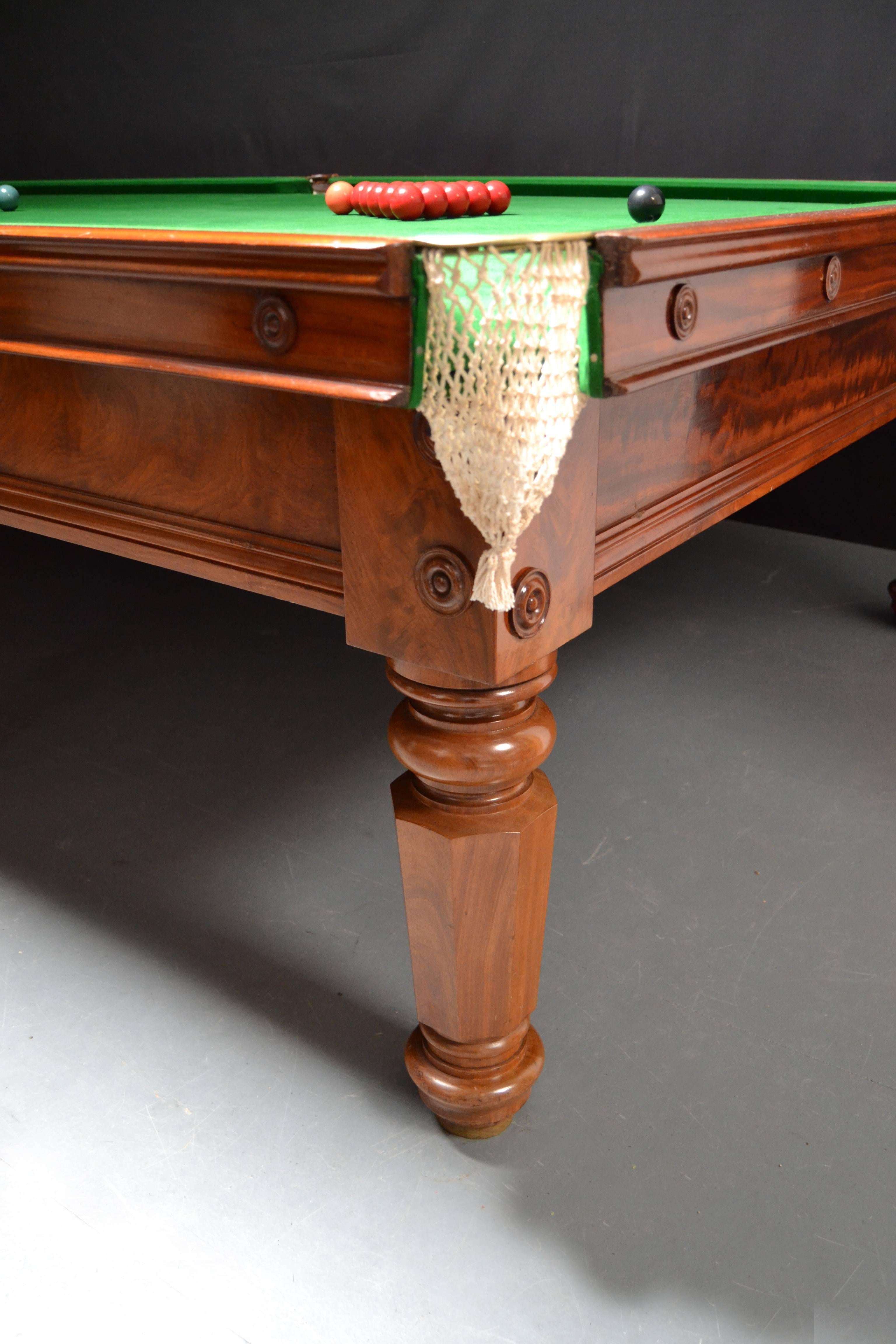 A superb feathered mahogany billiard, snooker table, circa 1850 standing on eight elegant turned octagonal legs with applied decorative bosses to the cushion friezes and leg blocks. An outstanding cut of mahogany veneer has been used on this table,