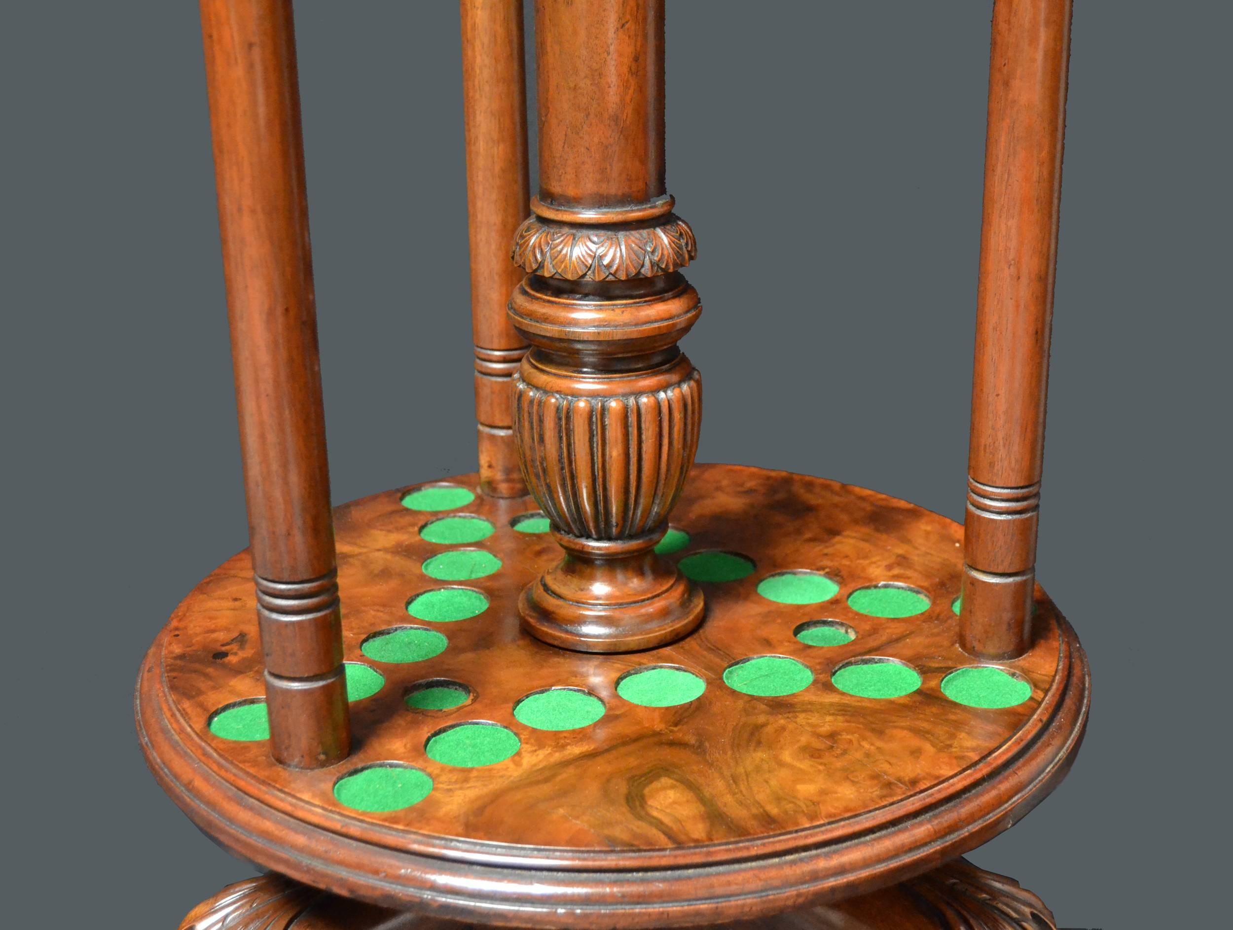 An imposing solid walnut Billiard cue stand of fabulous stature and quality, of carousel design standing on three massive carved paw feet, the revolving turntable base is supported by a central decorative column which is mounted with a gadrooned