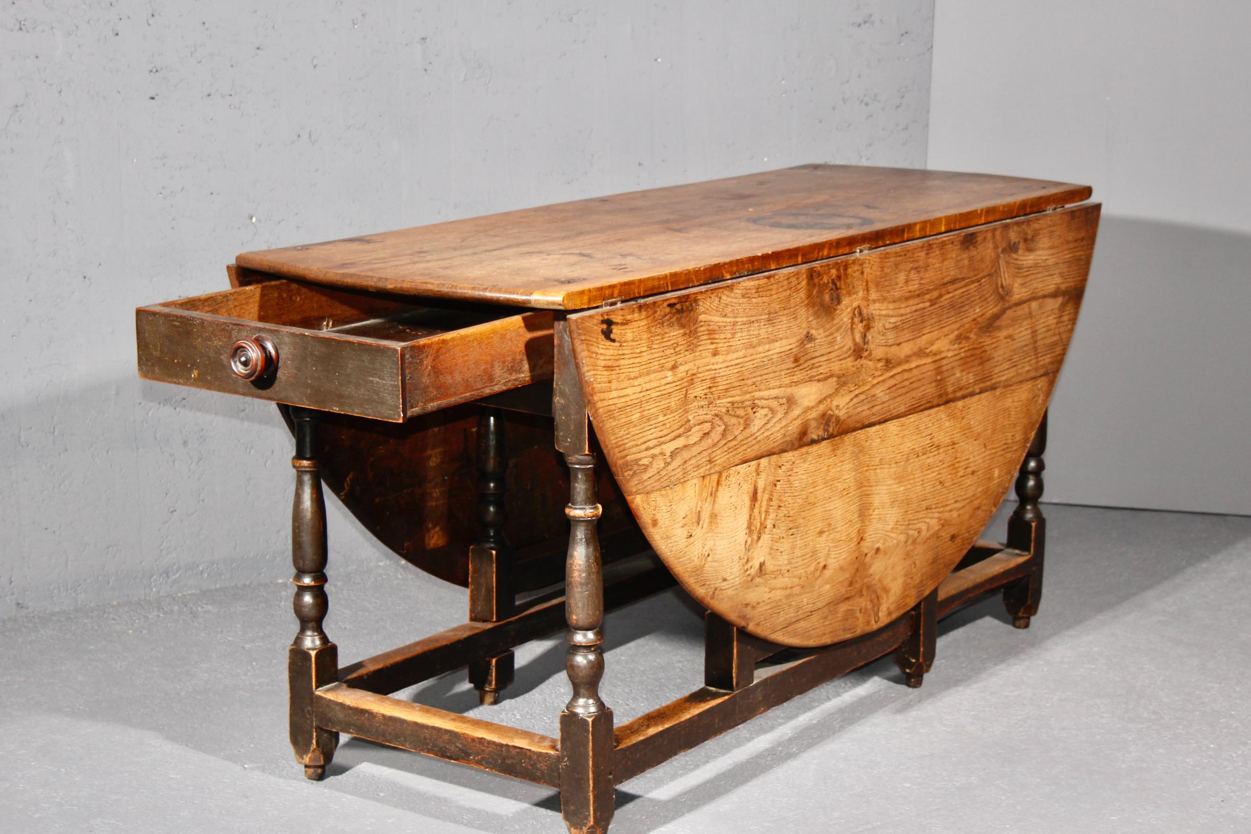 European oak table with one drawer and two folding extensions, beautiful patina For Sale