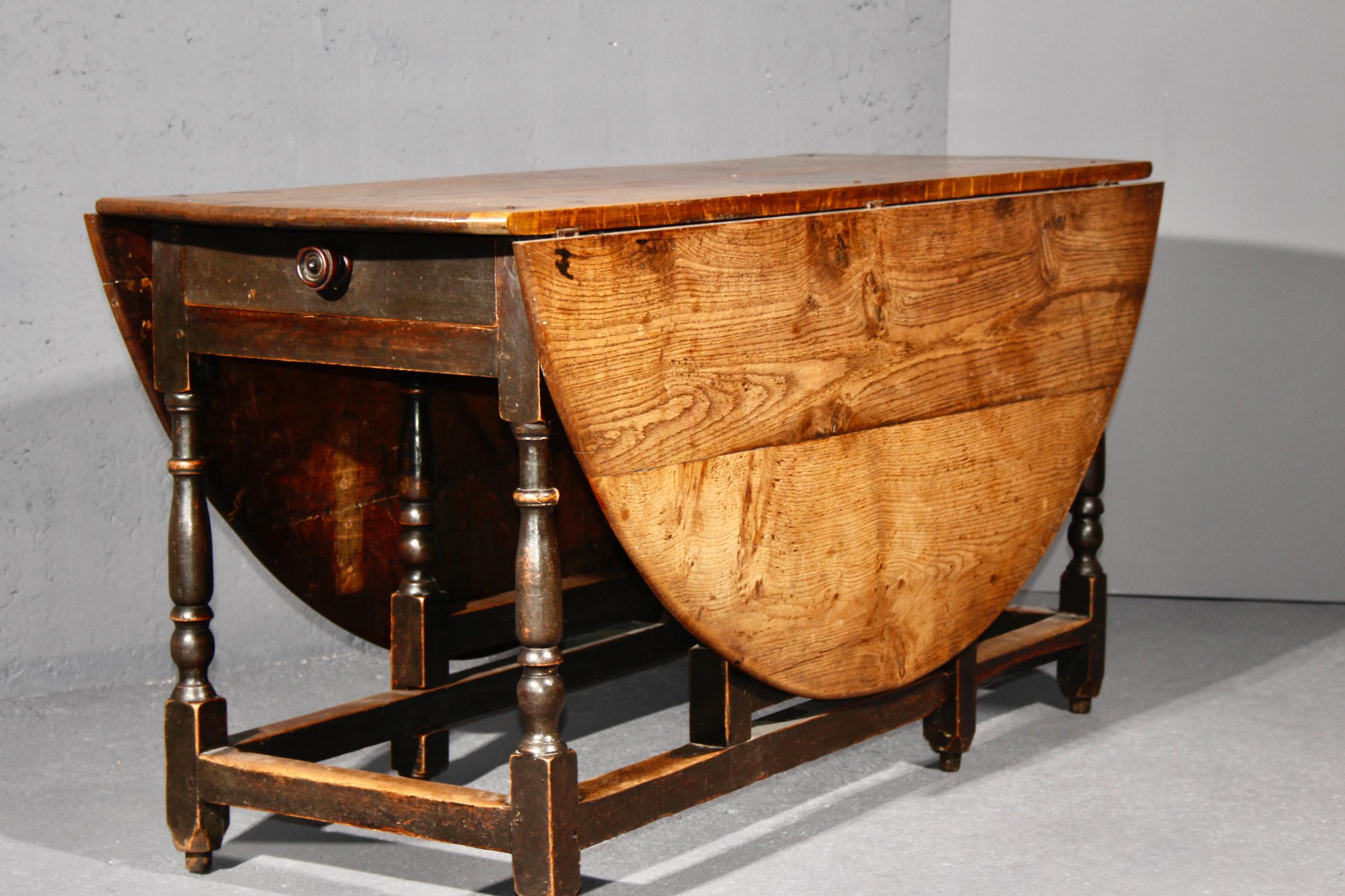 oak table with one drawer and two folding extensions, beautiful patina little part of the top has been restored see photo