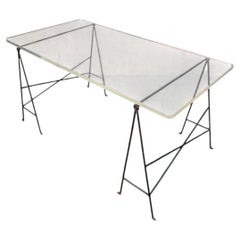 Desk consisting of two wrought-iron trestles and a thick Plexiglas top