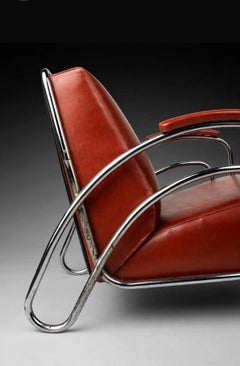 Pair of moderniste tubular and red leather armchairs