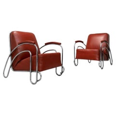 Pair of moderniste tubular and red leather armchairs