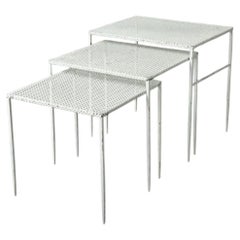 white perforated sheet metal nesting tables by Mathieu Matégot