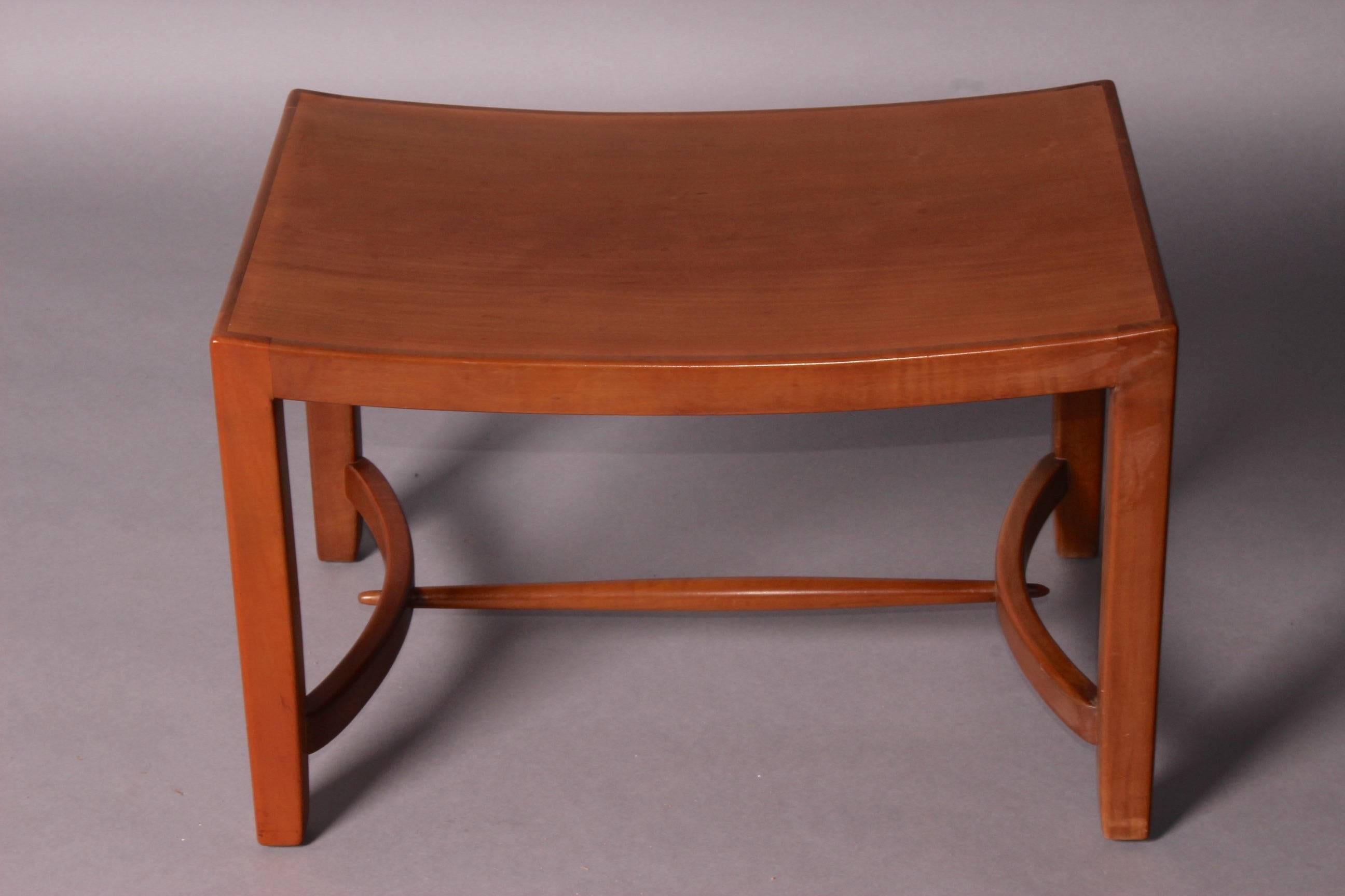 Curved wood stool.