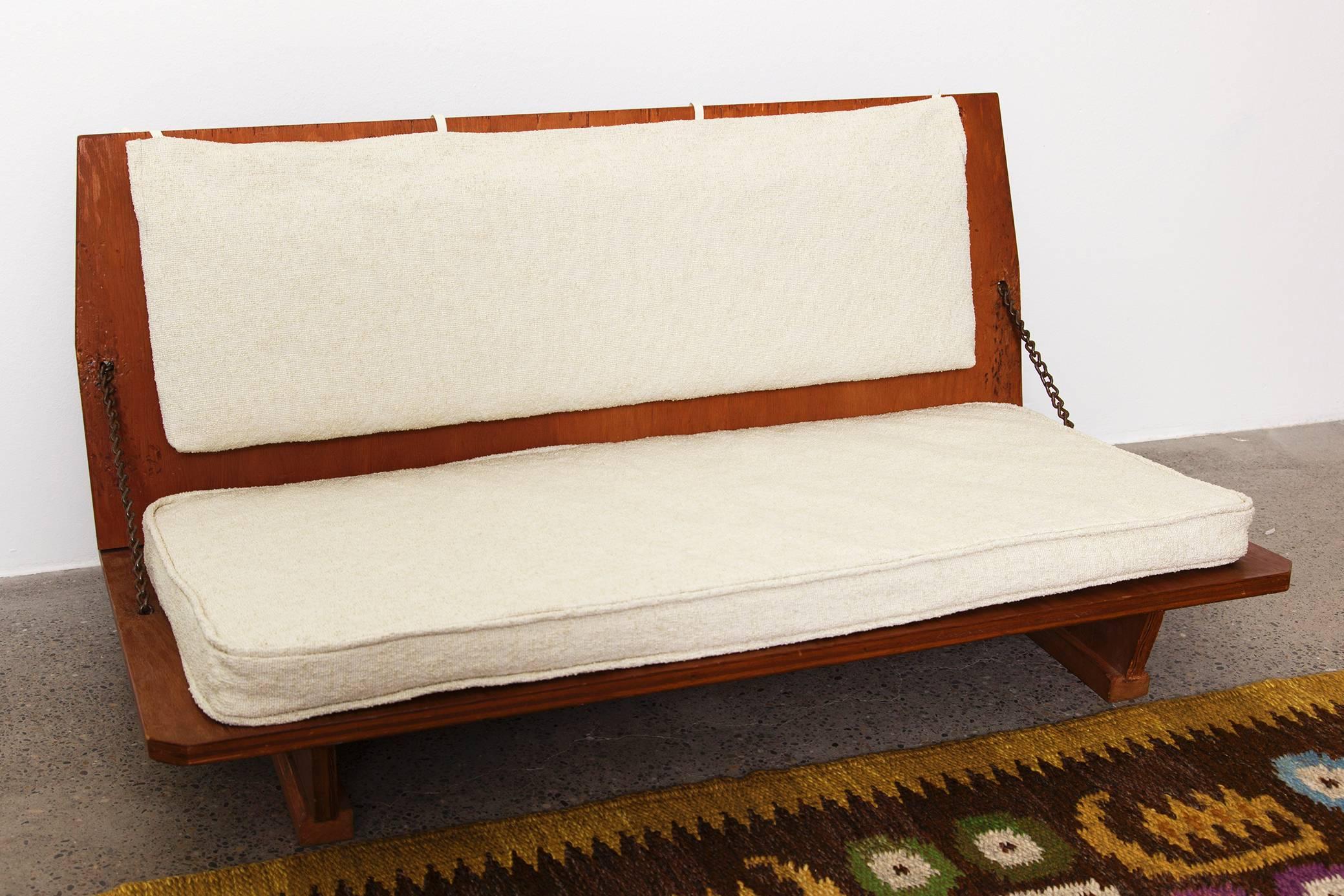 A pair of original benches by Frank Lloyd Wright from the Unitarian Church in Madison, USA, 1951. They are foldable, in stained pine plywood, chains on both sides and newly upholstered in a white cotton linen mix fabric. They still have the original