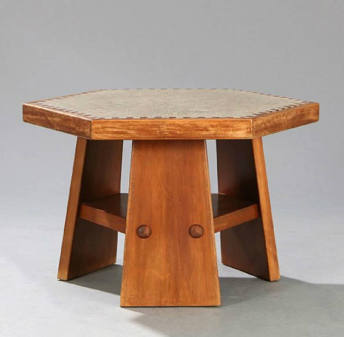 A hexagonal stained beech coffee table with a mosaic top in grey and red and an underlying shelf. By a Danish cabinetmaker, Denmark circa 1950's.