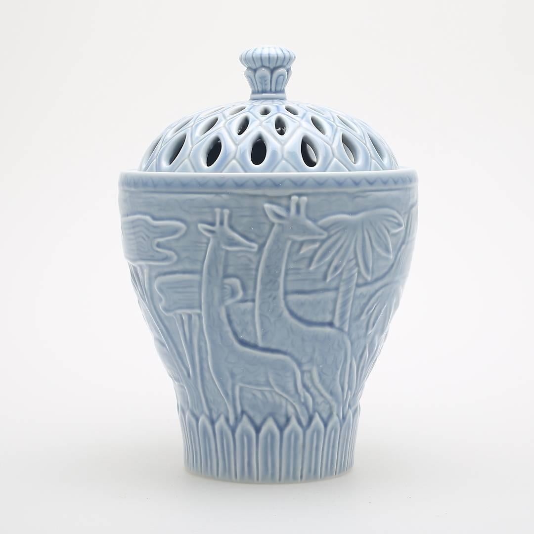 A sky blue porcelain jar with lid by Gunnar Nylund, Sweden, 1940s. With exotic animal and nature reliefs in style of painter Henri Rousseau. Signed GN for Gunnar Nylund, numbered 27/50 as limited edition and showing the manufacturer stamp Rörstrand.