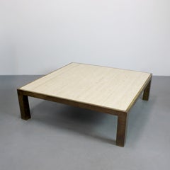 Coffee table with an aged gold-tone brass frame and a travertine marble top