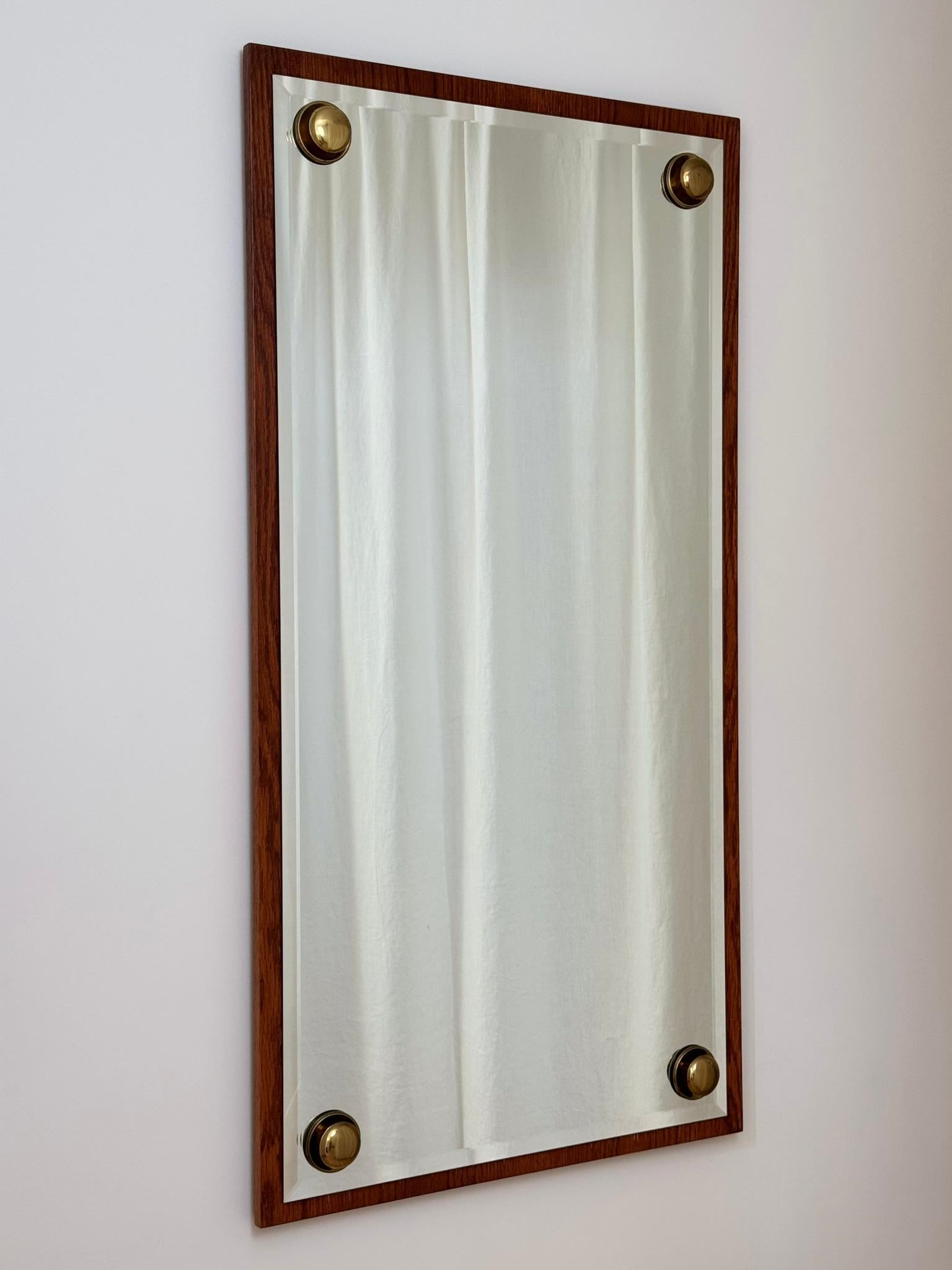 A large mirror with oversized brass studs produced by Glas & Trä. Good vintage condition except for a small horizontal scratch to the middle-right of the glass (visible in third image). Maker's label on the reverse.

Worldwide shipping