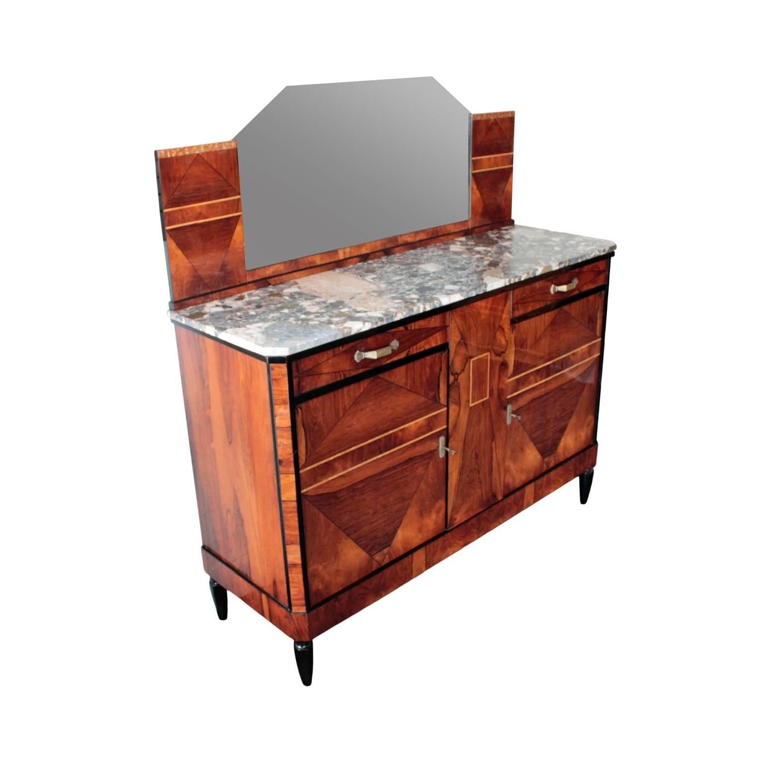 Well sized and striking server having a removable mirror with canted corners resting on a cabinet in book-matched rosewood with Italian marble top, pair of drawers and pair of doors enclosing full width single shelf. The whole parcel ebonized and