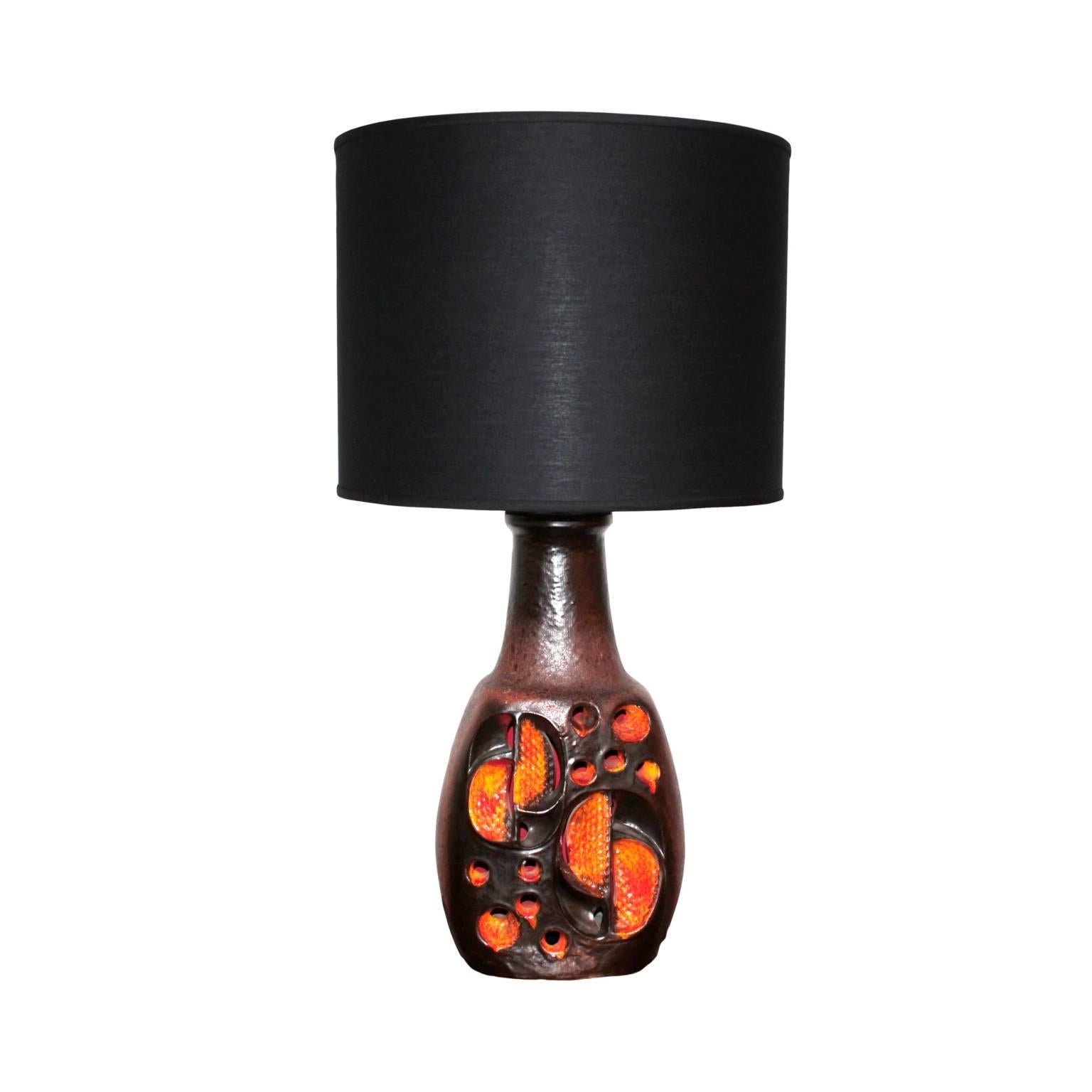 Vase shaped body in ceramic and glazed ceramic, interior fitted with a single light bulb; neck with single bulb and a large black cotton drum shade.