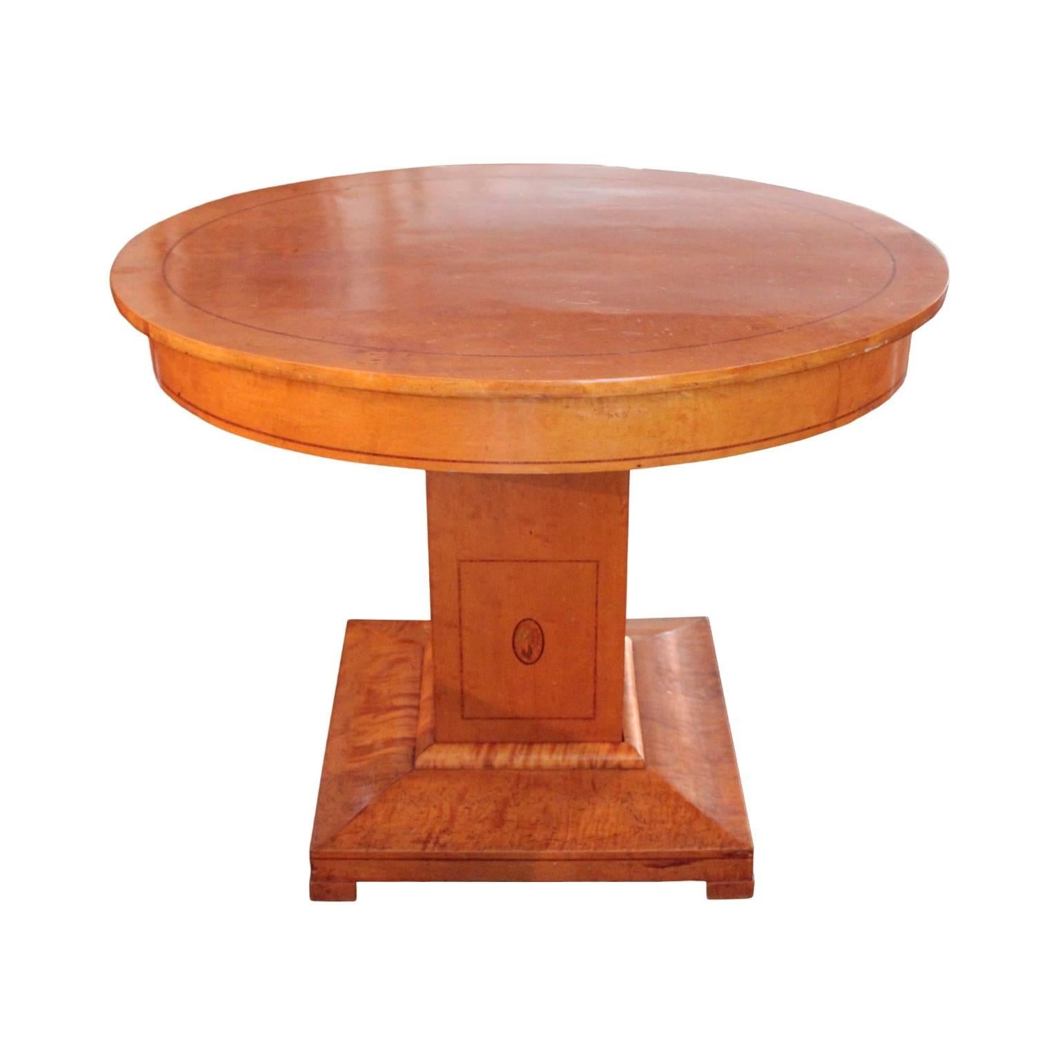 Table top and apron inlaid with rosewood banding. Raised on a cuboid pedestal decorated on all four sides with rectangular frame inlay in rosewood corresponding with the rectangular shape of the pedestal and smaller oval frame inlay in rosewood