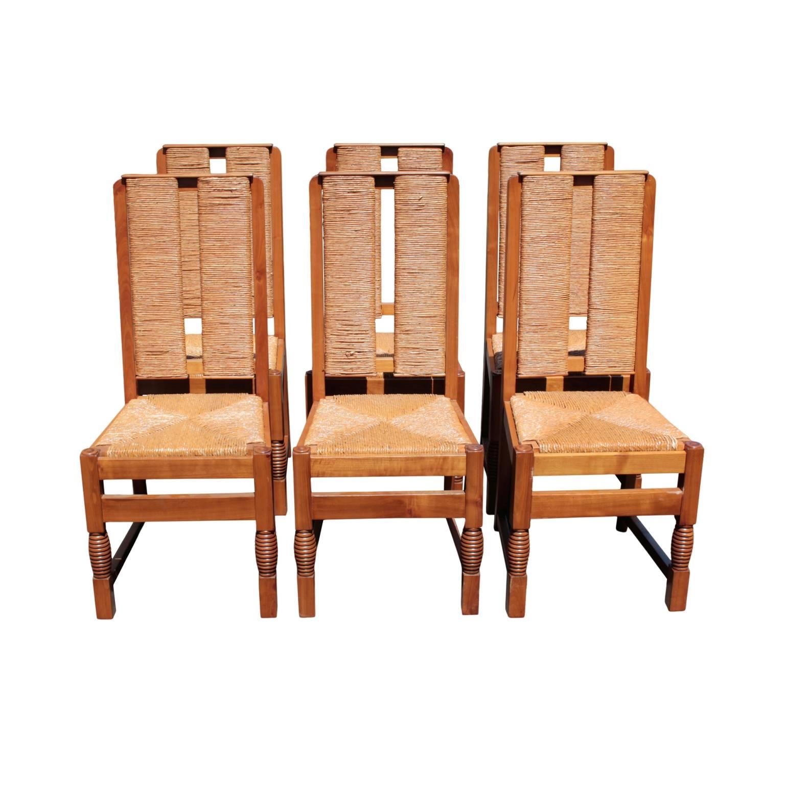 Art Moderne set of sculpted chairs belonging to the table Combray Gallery ref# CT11 designed by Victor Courtray (1896-1987). Backs and seats with weaved rush. In cherry. Biarritz, France. 