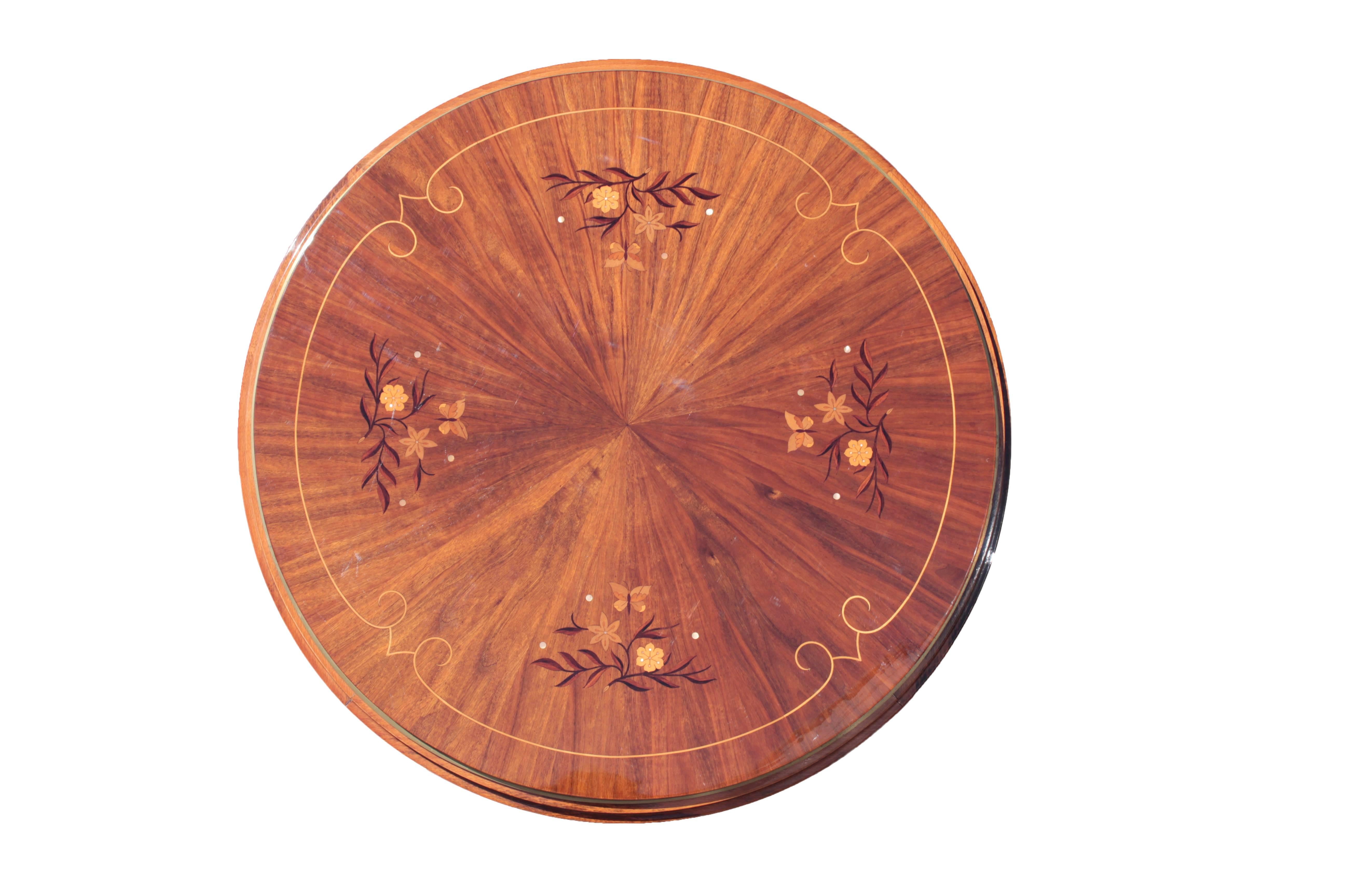 Bookmatch veneered palisander and beech stepped top banded with a large brass ring and decorated with inlays in mahogany, sycamore, walnut, maple and mother-of-pearl depicting flowers and butterflies; raised on four tapered conical legs in beech,