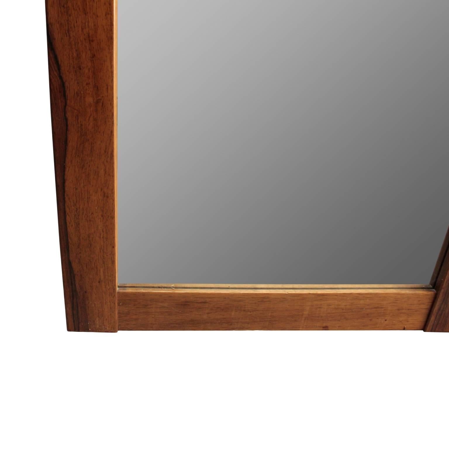 Swedish Mid-Century Modern wall mirror. Minimalist rectangular frame in palisander. Retaining original label.