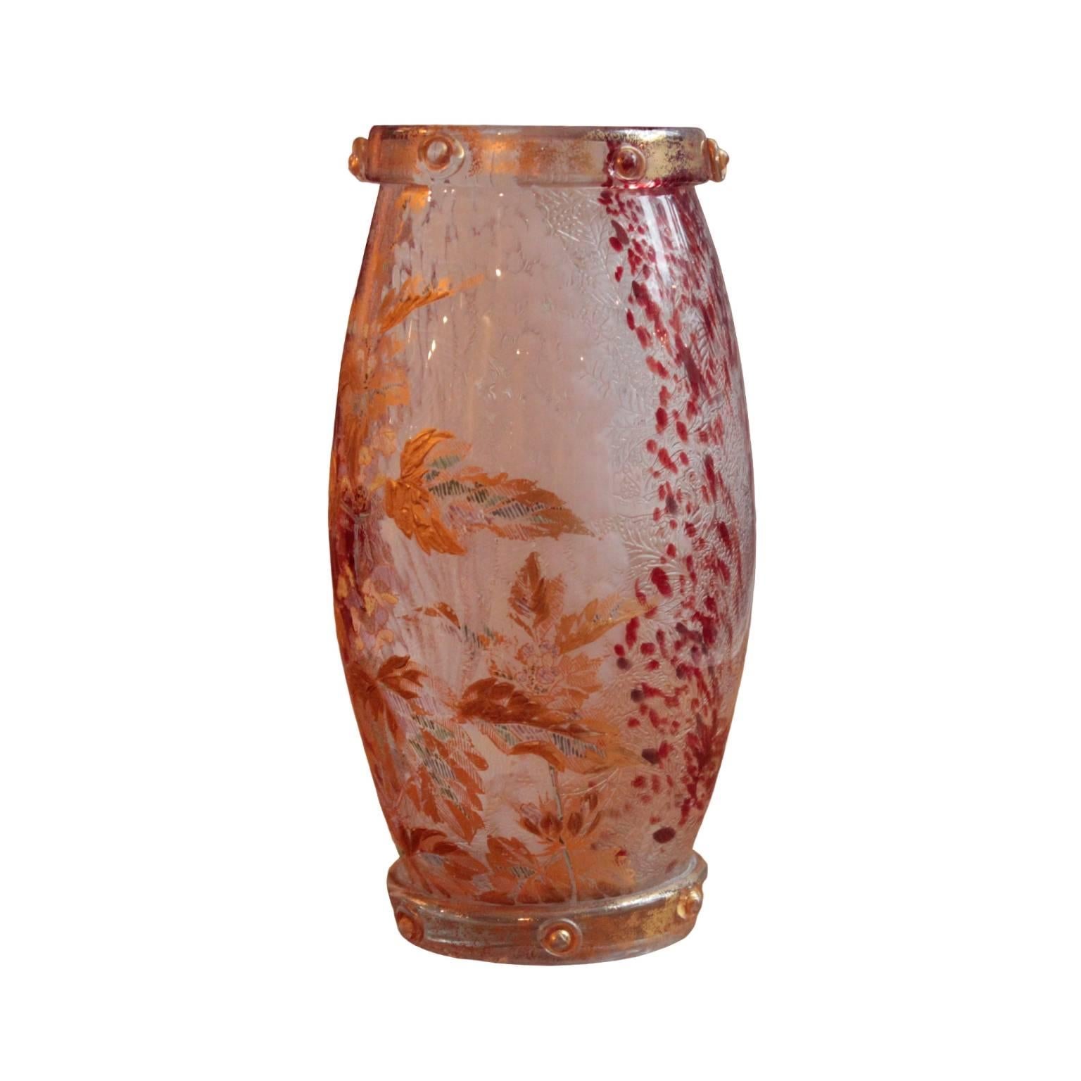 Of oblong shape; featuring dual glass-layered body, interior layer thoroughly etched with foliage motif and decorated with white and red hand applied paint, exterior layer decorated with hand-painted plant in gold, turquoise and blue. Top and base