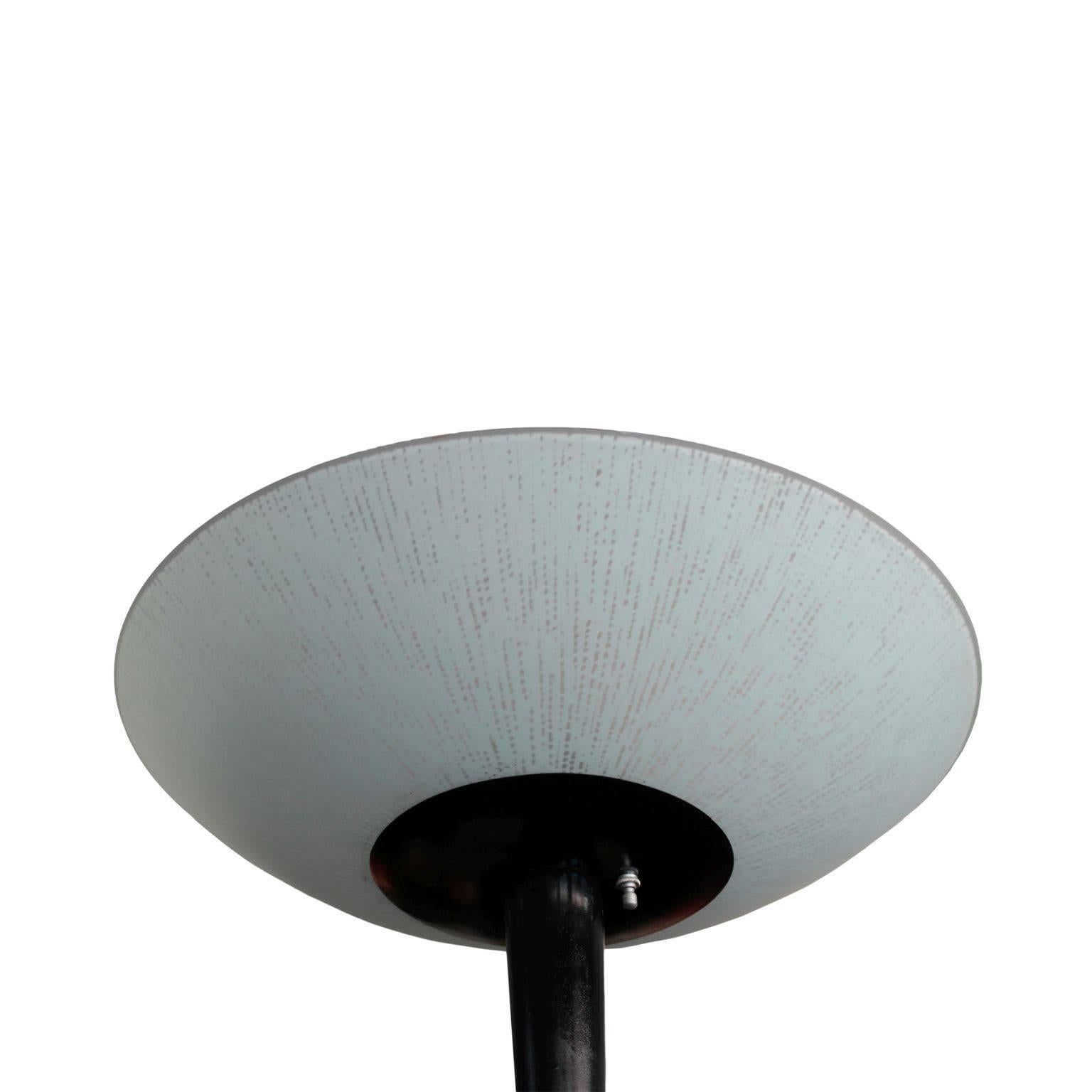 In Art Deco style, featuring frosted glass disc shaped diffuser, channeled post and disc shaped base in black metal. Fitted with three light bulbs. Some paint wear on the base. Most likely produced by Lightolier.