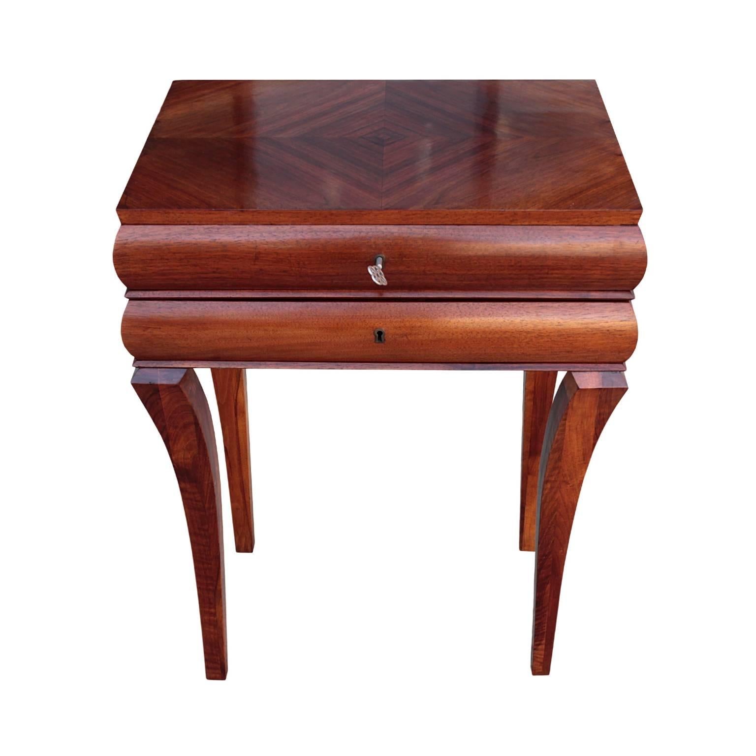 Rare and fine German Art Deco period beautifully sculpted side table featuring rectangular bookmatched top resting on two joined bombe segments, each enclosing a drawer. The whole raised on four shaped in-curving and tapering sabre legs. In
