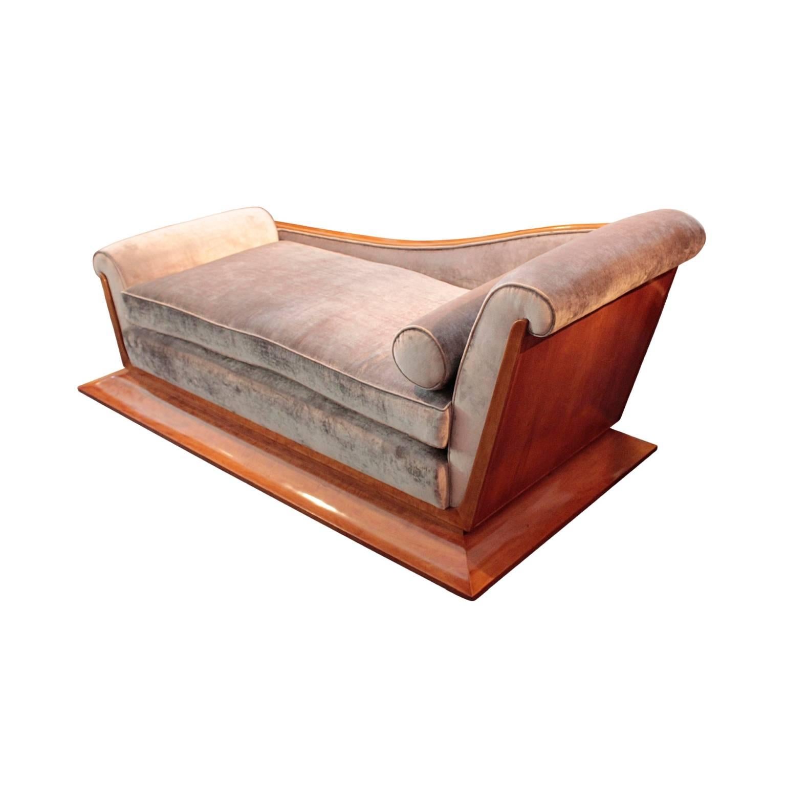 Exquisite French Art Deco period Recamier designed by Dominique (Andre Domin & Marcel Genevriere). Of classical design and sculptural quality featuring frustum shaped plinth base, fully veneered back and sides, large pillow seat and one bolster.