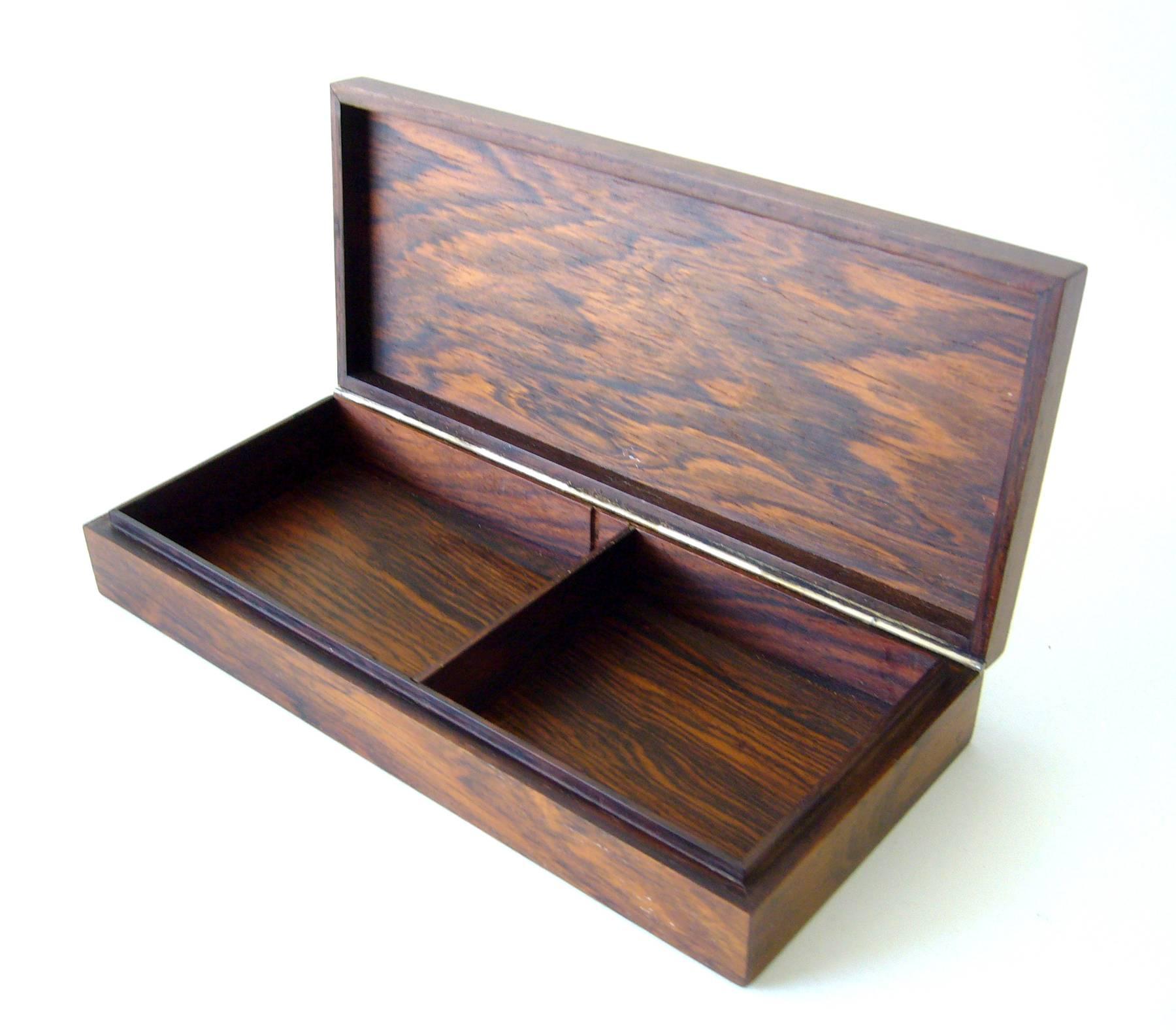 Rosewood box and lighter with sterling silver inlay designed by Hans Hansen of Denmark.  Box measures 1 3/4