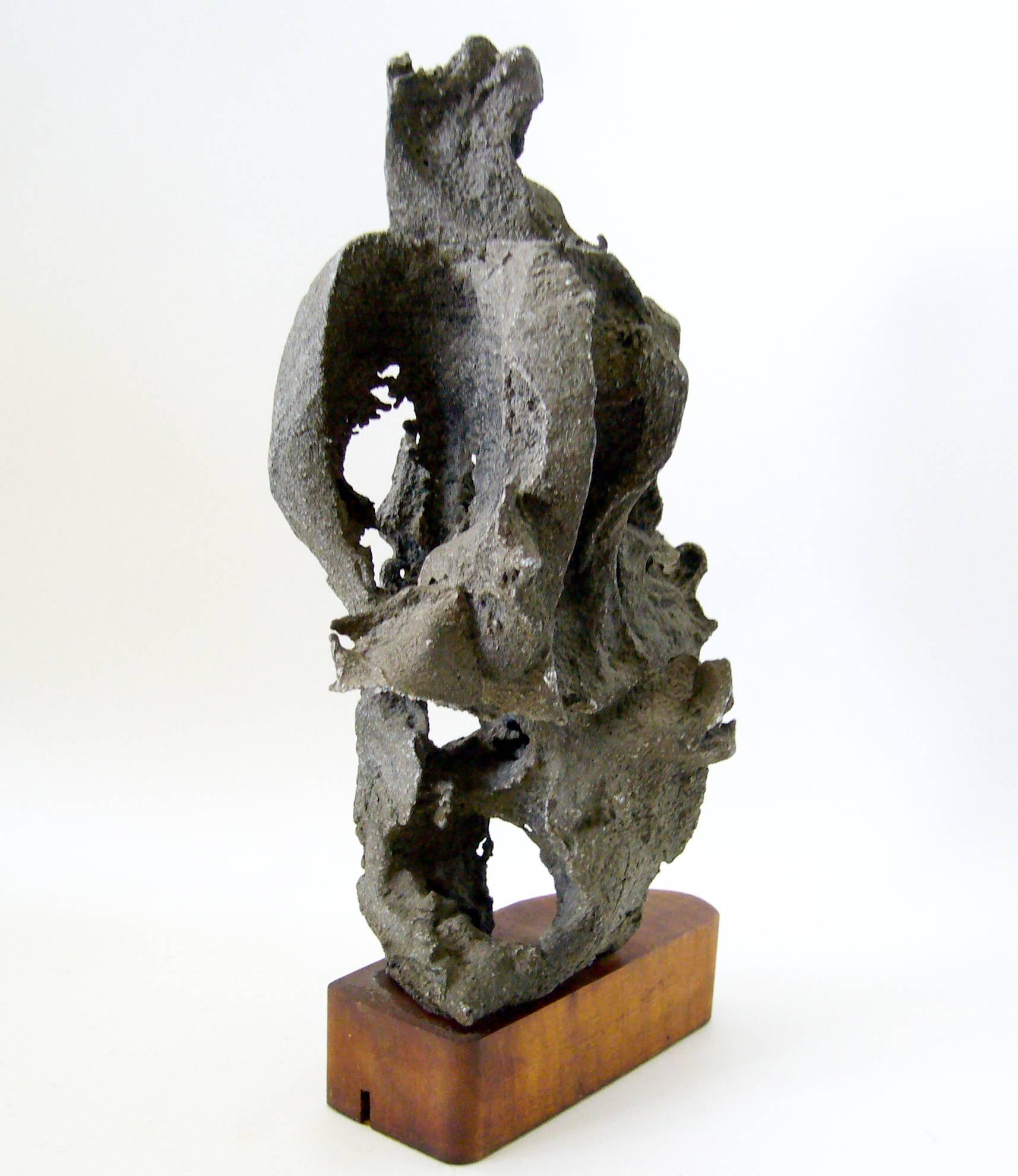 Abstract modernist aluminum sculpture on found wood base, circa 1960s. Sculpture measures 12" high by 7" wide by 5" deep and is unsigned. From the unknown artists' estate in Altadena, California. In very good vintage condition.