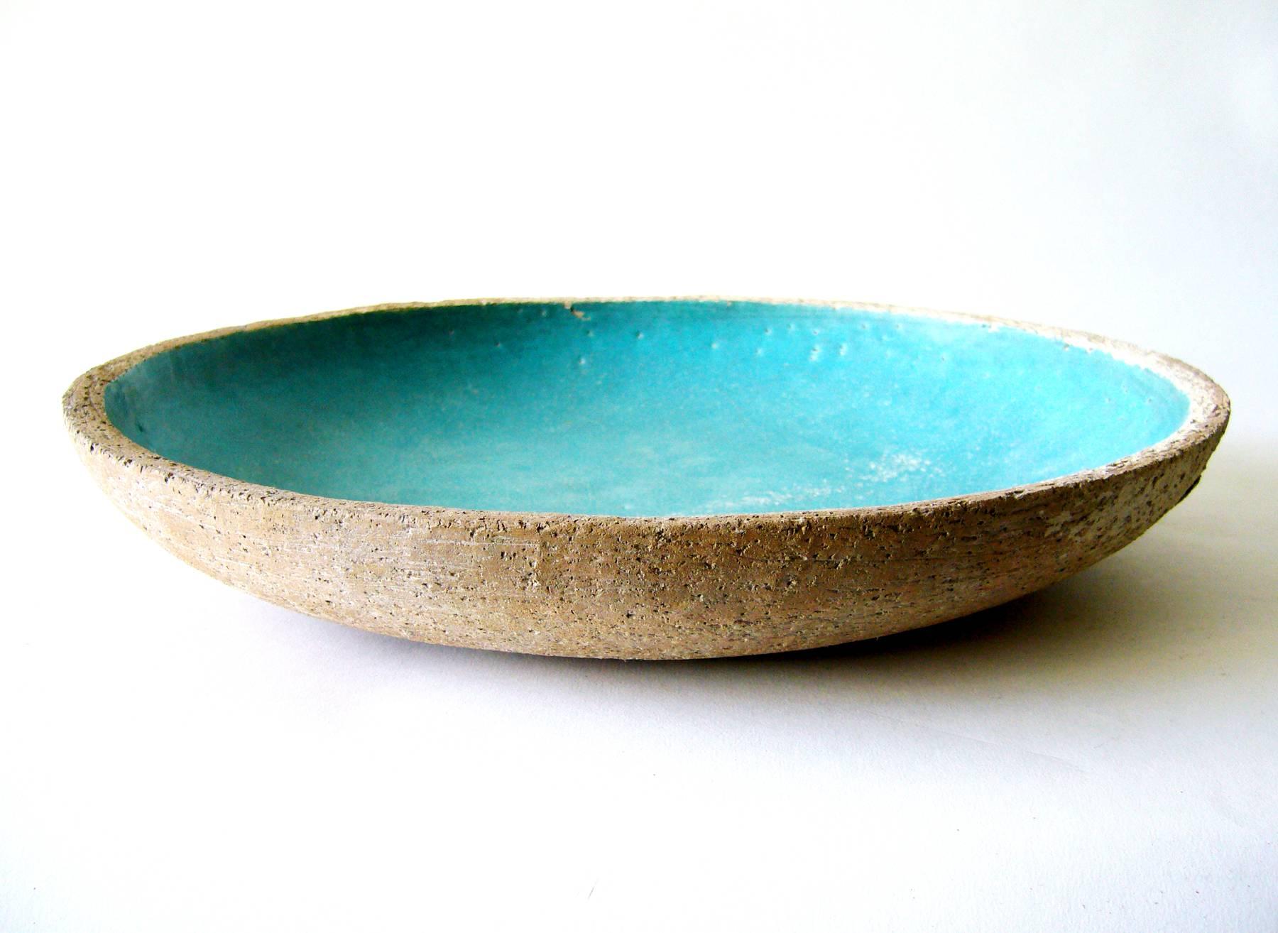 Large, open stoneware bisque bowl with turquoise blue glazed interior created by Barbara Willis of California. Willis studied with studio ceramist Laura Andreson at UCLA and was influenced by Glen Lukens of USC. Willis had a studio in Los Angeles