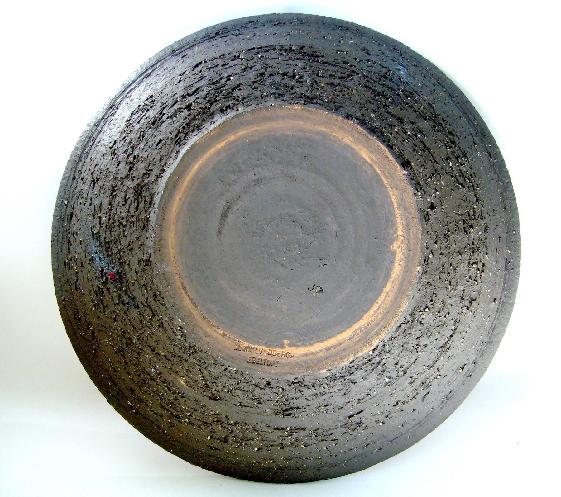 Mid-Century Modernist ceramic charger created by Ulrik Lundbergh of Ebeltoft, Denmark. Platter measures 12.5
